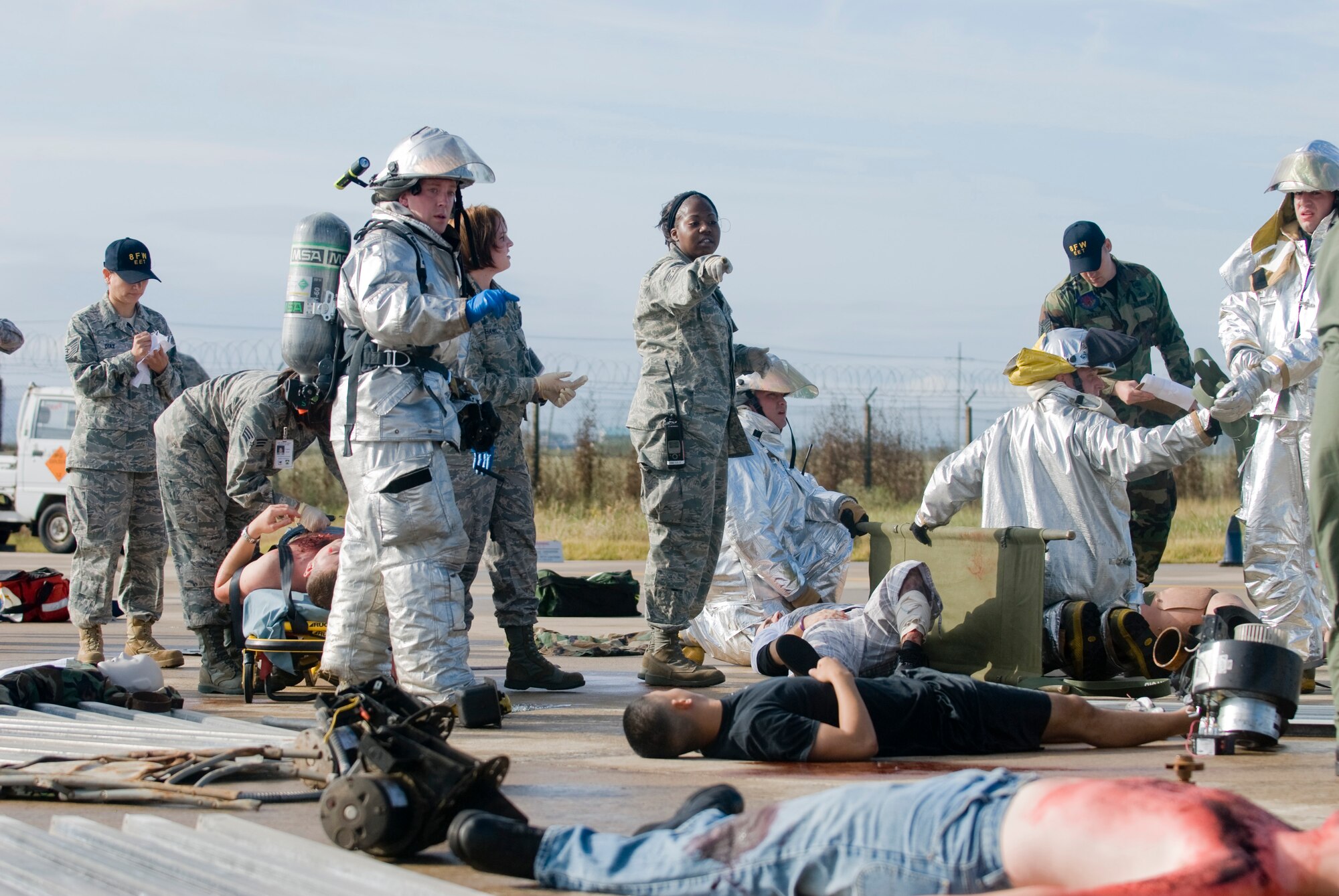 KUNSAN AIR BASE, Republic of Korea -- First responders attend to simulated casualties in the middle of a simulated aircraft mishap during an emergency management exercise Sept. 28. The EME tested Kunsan's first responders, as well as command and control, on handling an aircraft mishap during an air show. (U.S. Air Force photo/Senior Airman Jonathan Steffen)