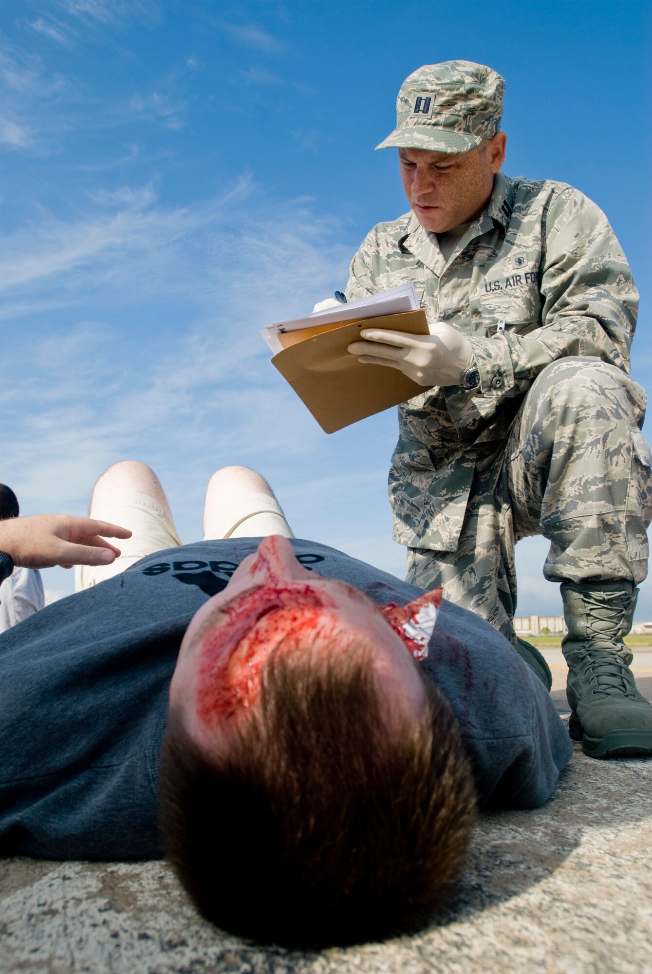 KUNSAN AIR BASE, Republic of Korea -- Capt. Scott Leblanc, 8th Medical Group, diagnoses a simulated wounded personnel during an emergency management exercise Sept. 28. The EME tests Kunsan's first responders on how they would handle an aircraft mishap during an air show. (U.S. Air Force photo/Senior Airman Jonathan Steffen)