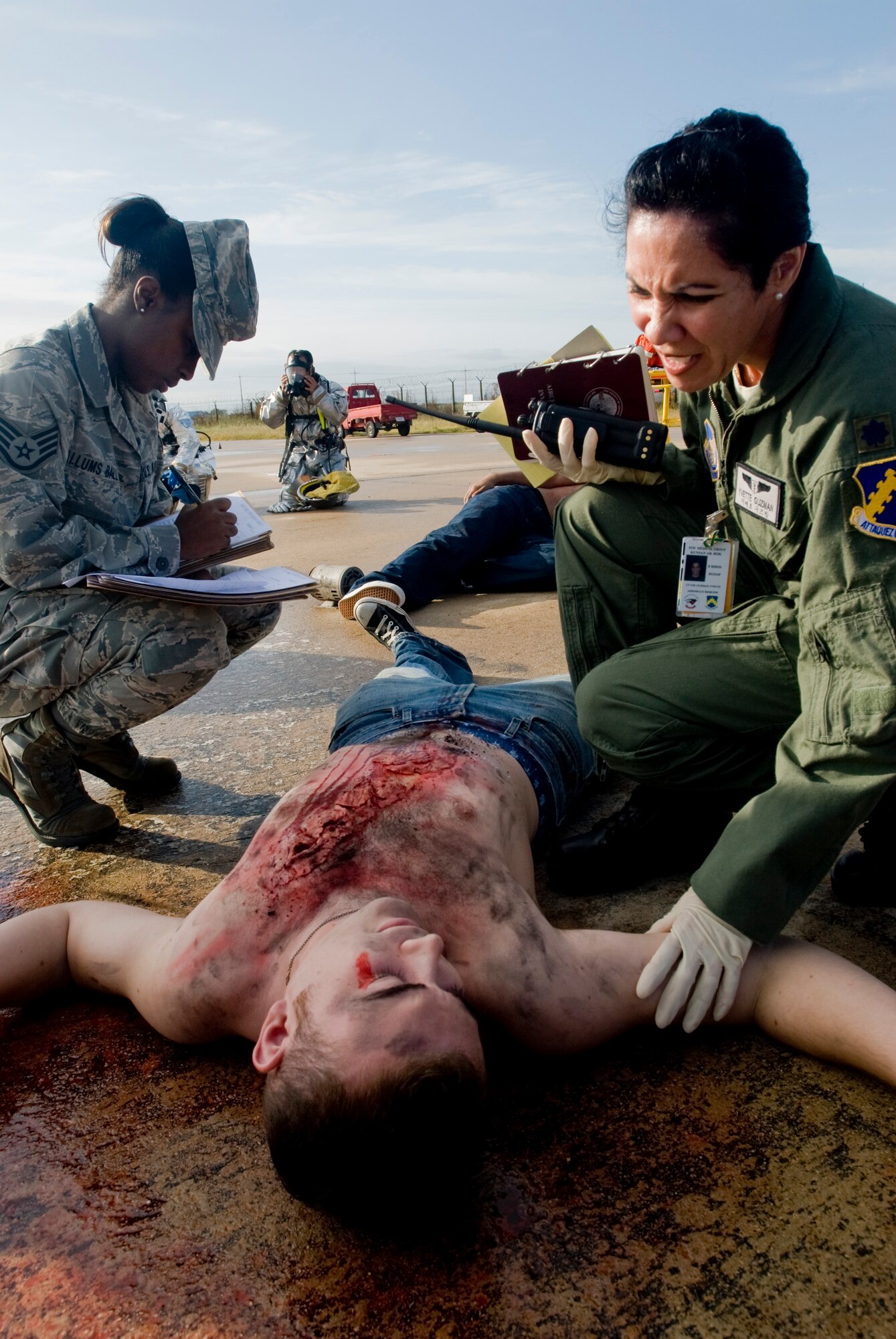 KUNSAN AIR BASE, Republic of Korea -- Staff Sgt. Nicole Allums Ball, 8th Medical Support Squadron, and Lt. Col. Yvette Guzman, 8th Medical Operations Squadron, attend to wounded personnel during an emergency management exercise Sept. 28. The EME tests Kunsan's first responders, as well as command and control, with various potential scenarios, particularly if there is an aircraft mishap during an air show. (U.S. Air Force photo/Senior Airman Jonathan Steffen)