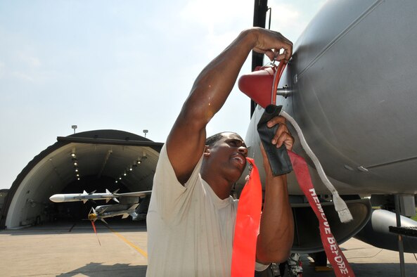 Staff Sgt. Erik Bedenfield, a crewchief with the 8th Aircraft Maintenance Squadron, 35th Aircraft Maintenance Unit, secures an F-16 Fighting Falcon and performs a post flight inspection at Kunsan Air Base, Republic of Korea, Sept. 17. The 35th AMU maintainers inspected about 12 F-16s before the pilots deployed the jets to Eielson Air Force Base, Alaska, for Distant Frontier and Red Flag Alaska. (U.S. Air Force photo/Capt. Shannon Collins)
