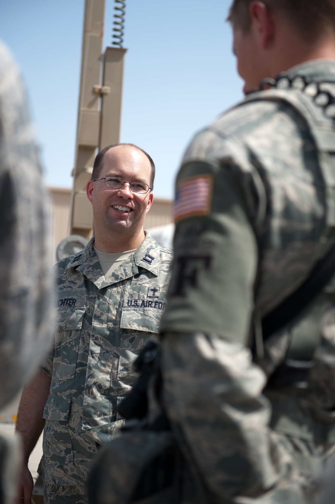 Chaplain (Capt.) Mark Juchter, 379th Air Expeditionary Wing, visits with Airmen from the 379th Expeditionary Security Forces Squadron, Sept. 24, in Southwest Asia. Chaplain Juchter leads the weekly traditional Protestant service and visits regularly with Airmen around the base. Chaplain Juchter is deployed from Tinker Air Force Base, Okla., to provide ministry for servicemembers deployed in support of Operations Iraqi and Enduring Freedom. (U.S. Air Force photo/Staff Sgt. Robert Barney) 