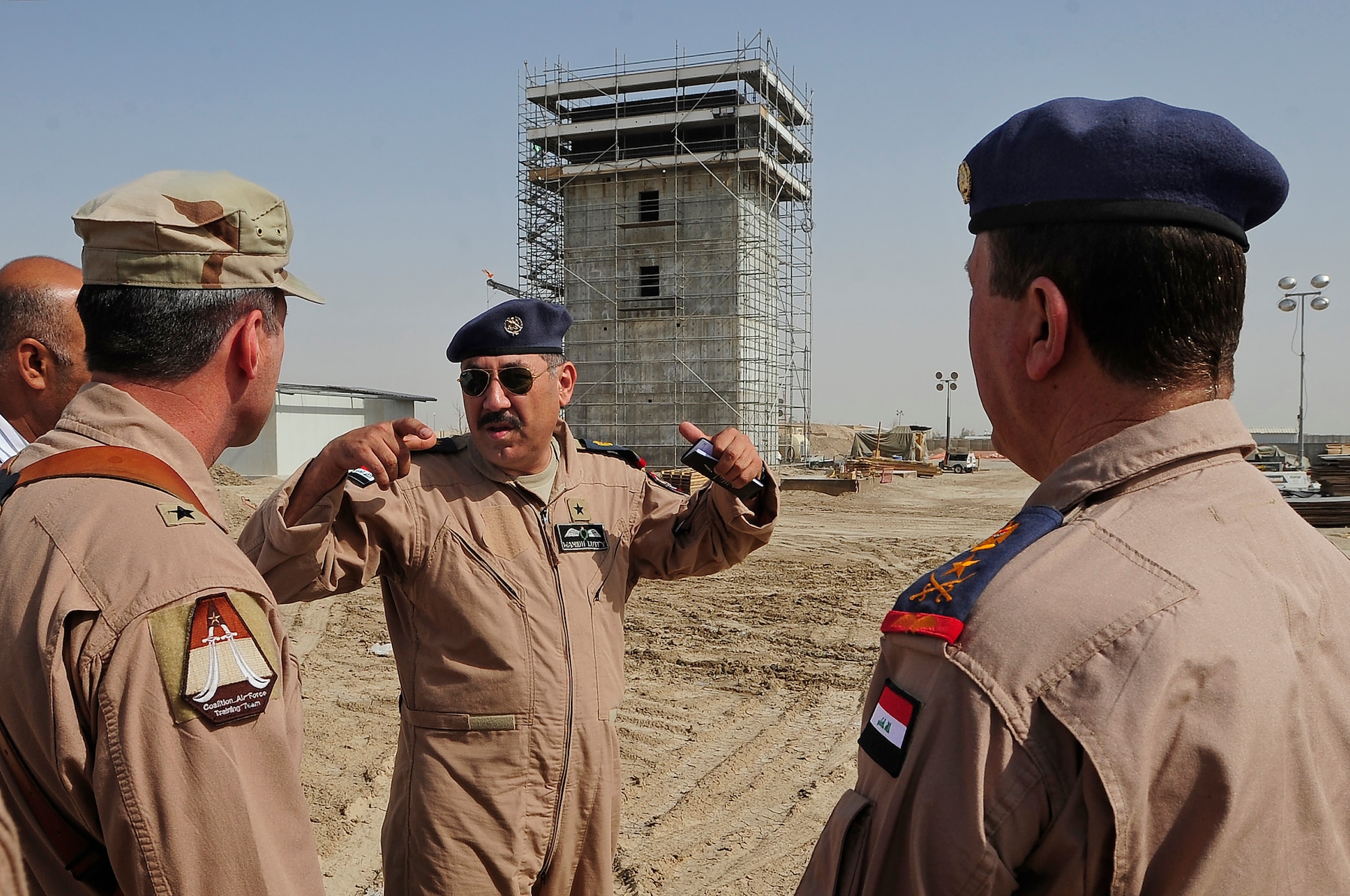 ALI Base, Iraq - (left to right) U.S. Air Force Maj. Gen. Robert Kane, director, Iraq Training and Advisory Mission – Air Force, Staff Brig. Gen. Wamidh, Iraqi Air Force Operations commander, and Staff Lt. Gen. Anwar Hamad Amen Ahmed, Iraqi Air Force commander, discuss the on-going construction of the new air traffic control tower here, Sept. 24, 2009. The was the first joint visit by General Anwar and General Kane, and marked a significant step in providing the Iraqi Air Force with a better understanding of what assets will be available to support them here when the base is transitioned to the Government of Iraq. (U.S. Air Force photo/Senior Airman Tony R. Ritter)