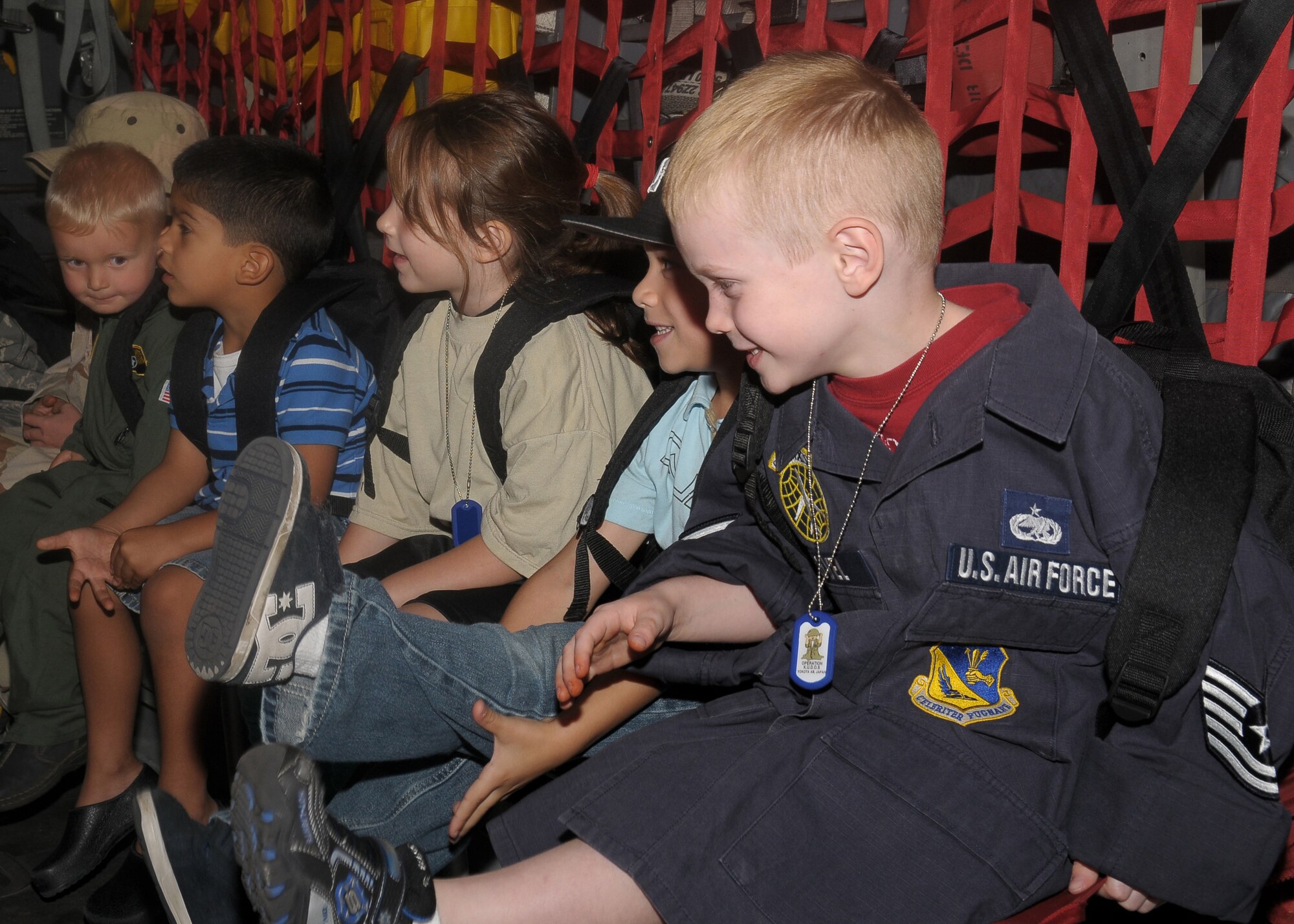 YOKOTA AIR BASE, Japan -- Children prepare for a mock C-130 flight to a simulated deployed location Sept. 26 during the base's Kids Understanding Deployment Operation Support event at Bldg. 400. K.U.D.O.S. is an annual event to help children better understand their parents' deployment by going through part of the process themselves. More than 275 children attended this year's event. (U.S. Air Force photo/Airman 1st Class Sean Martin)