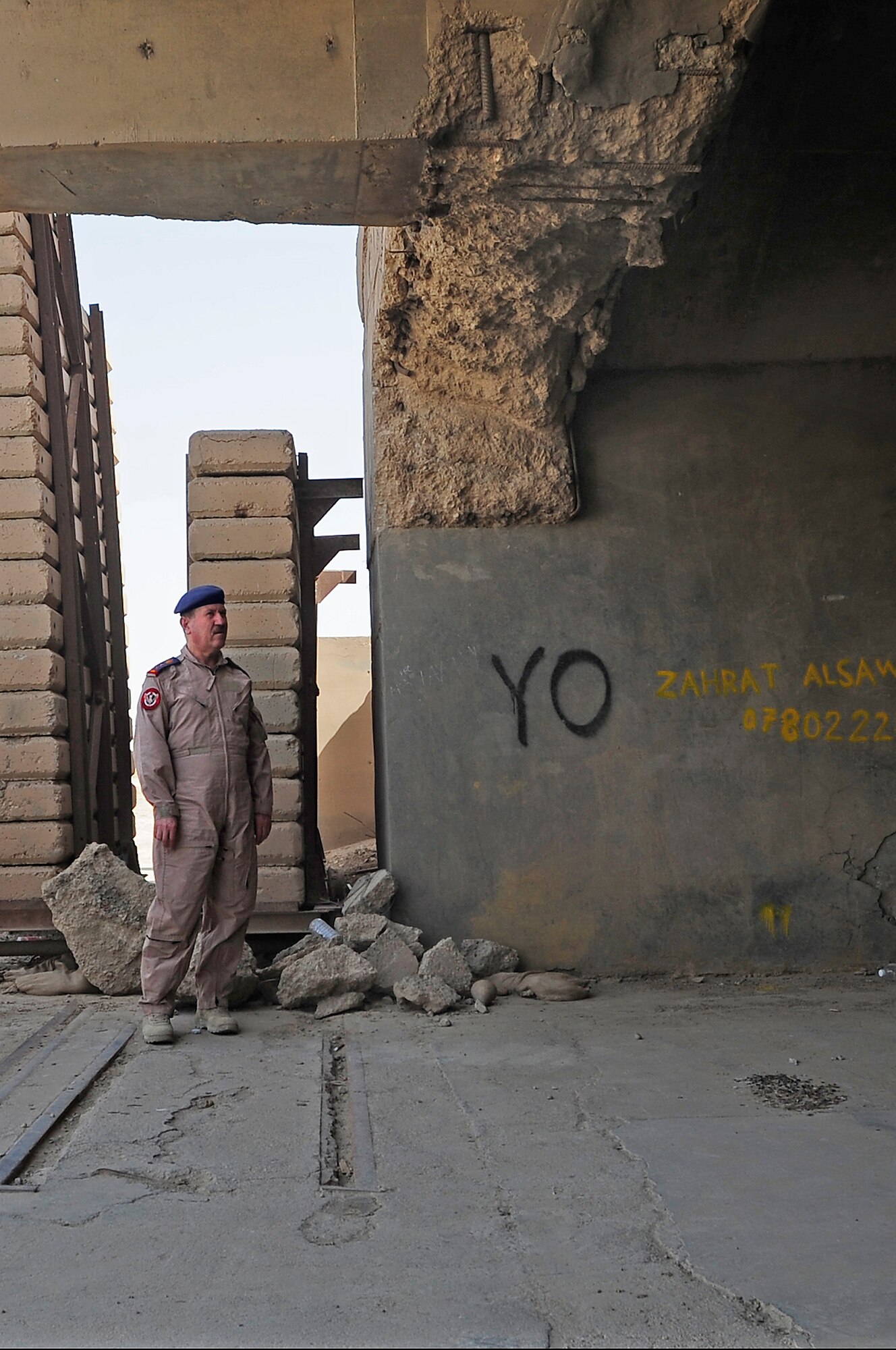 ALI BASE, Iraq - Staff Lt. Gen. Anwar Hamad Amen Ahmed, Iraqi Air Force Commander, surveys an aircraft hanger that is in need of repair during his visit here, Sept. 24, 2009. The visit by General Anwar to Ali Base marked a significant step in providing the Iraqi Air Force with a better understanding of what assets will be available to support them here when the base is transitioned to Government of Iraq. (U.S. Air Force photo/Senior Airman Tony R. Ritter)