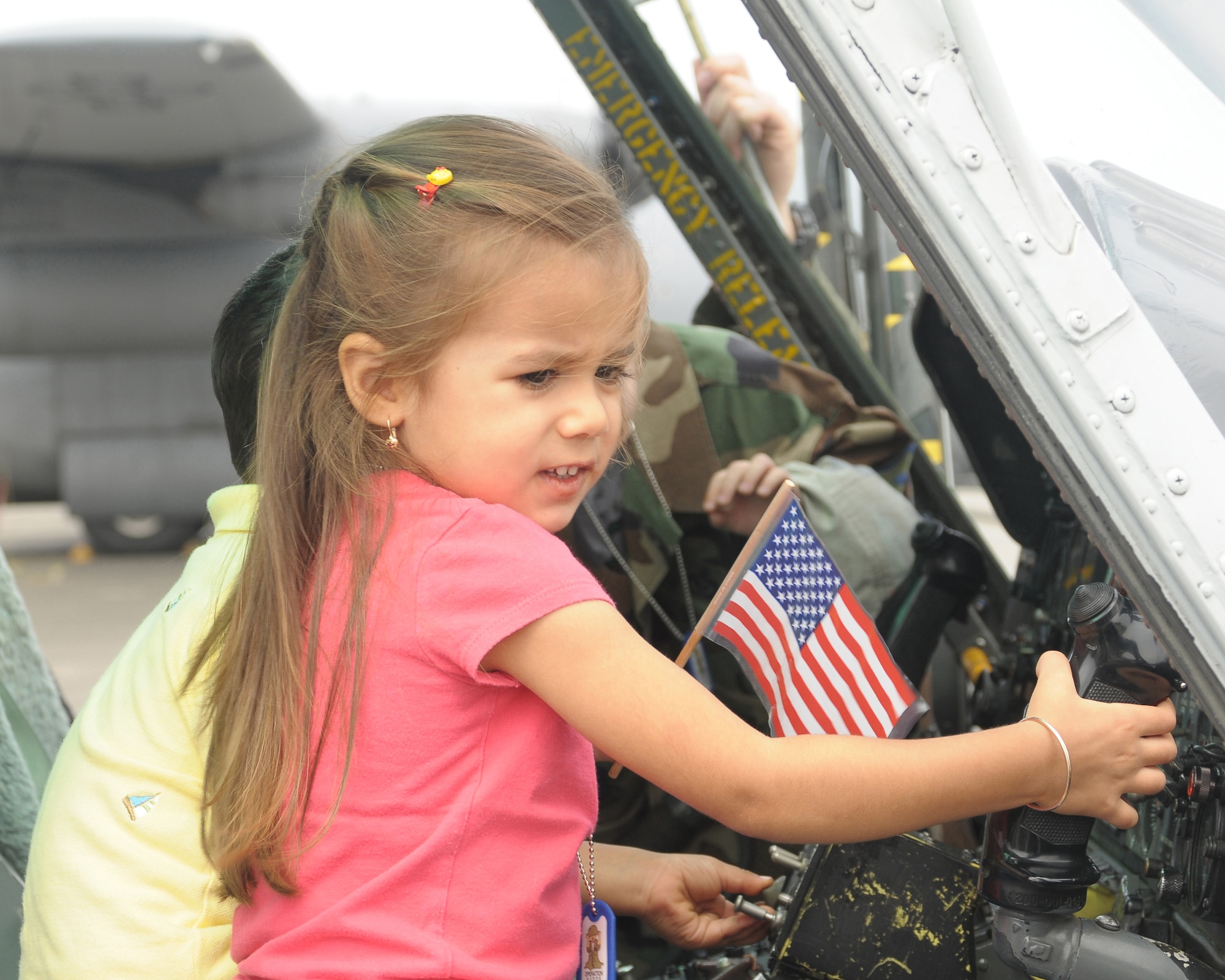 YOKOTA AIR BASE, Japan -- Mina Ramsook, daughter of Senior Master Sgt. Rabin Ramsook, 374th Force Support Squadron, sits in a UH-1N Huey helicopter Sept. 26 during the base's Kids Understanding Deployment Operation Support event at Bldg. 400. K.U.D.O.S. is an annual event to help children better understand their parents' deployment by going through part of the process themselves. More than 275 children attended this year's event. (U.S. Air Force photo/Airman 1st Class Sean Martin)
