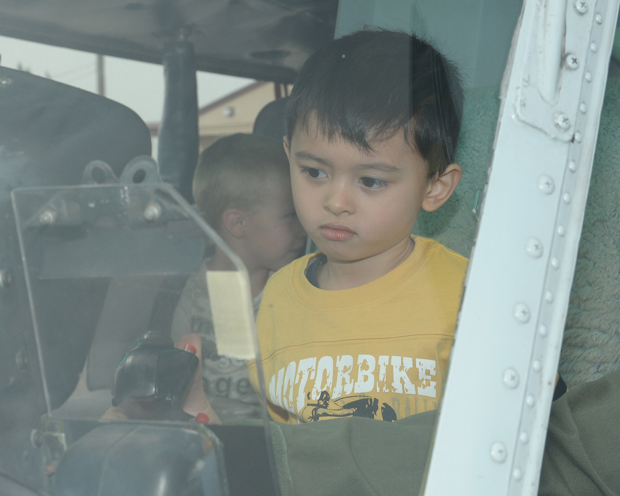 YOKOTA AIR BASE, Japan -- Kevin McKinney, son of Staff Sgt. Kevin McKinney, 374th Security Forces Squadron, sits in a UH-1N Huey helicopter Sept. 26 during the base's Kids Understanding Deployment Operation Support event at Bldg. 400. K.U.D.O.S. is an annual event to help children better understand their parents' deployment by going through part of the process themselves. More than 275 children attended this year's event. (U.S. Air Force photo/Airman 1st Class Sean Martin)