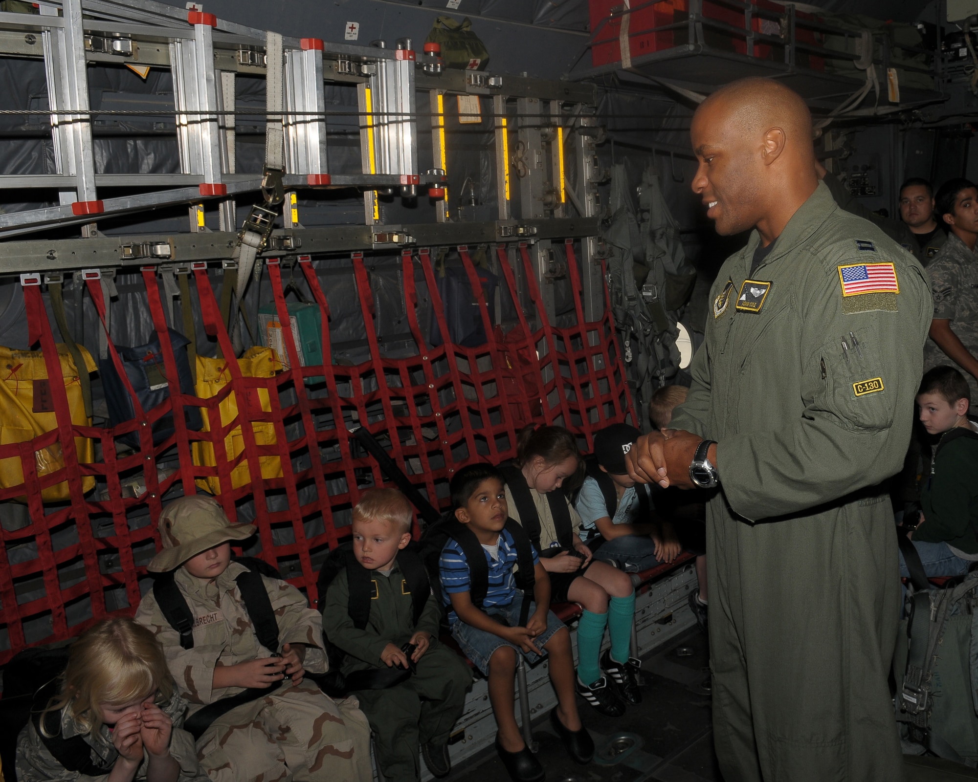 YOKOTA AIR BASE, Japan -- Capt. Adam Cole, 36th Airlift Squadron, briefs children on a mock flight to a simulated deployed location Sept. 26 during the base's Kids Understanding Deployment Operation Support event at Bldg. 400. K.U.D.O.S. is an annual event to help children better understand their parents' deployment by going through part of the process themselves. More than 275 children attended this year's event. (U.S. Air Force photo/Airman 1st Class Sean Martin)