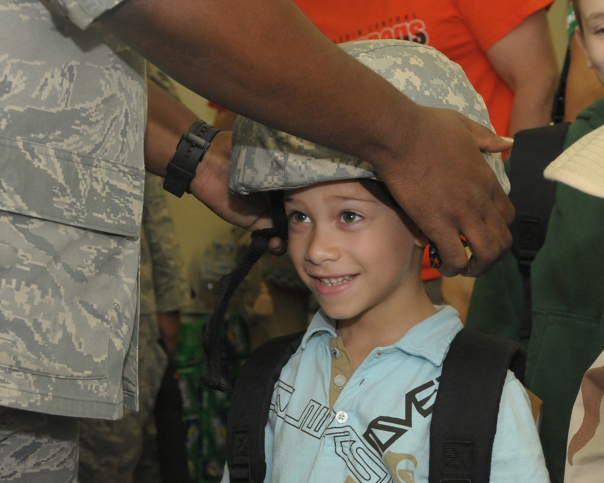YOKOTA AIR BASE, Japan -- Kangel Rivera, son of Staff Sgt. Luis Rivera, 374th Aircraft Maintenance Squadron, tries on a Kevlar helmet Sept. 26 during the base's Kids Understanding Deployment Operation Support event at Bldg. 400. K.U.D.O.S. is an annual event to help children better understand their parents' deployment by going through part of the process themselves. More than 275 children attended this year's event. (U.S. Air Force photo/Airman 1st Class Sean Martin)