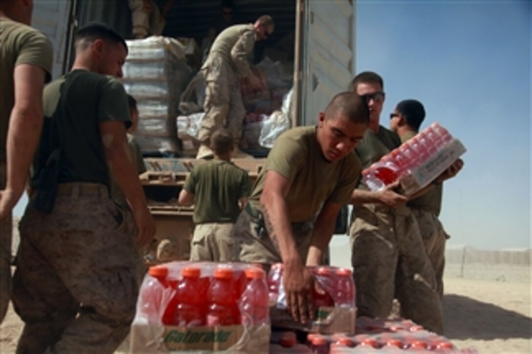 U.S. Marine Corps Cpl. Daniel Guerrero stacks cases of drinks as fellow Marines help unload a container at Fire Base Fiddler's Green in Helmand province, Afghanistan, on Sept. 20, 2009.  Guerrero is a fire direction controller attached to Headquarters Battery, 3rd Battalion, 11th Marine Regiment.  The Marines are deployed with Regimental Combat Team 3 to conduct counterinsurgency operations with Afghan National Security Forces in southern Afghanistan.  