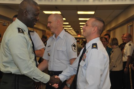 Maj. Gen. Abraham J. Turner, chief of staff, U.S. Strategic Command, shakes hands with the newest USSTRATCOM promotees during an event held Sep 29. The promotes for September are: Col. Richard Poore, Lt. Col. Patrick Franzese, Lt. Col. James Kafer, Maj. Steven Carter, Maj. Lloyd Olinger, Master Sgt. Jerry Alumbaugh, and Technical Sgt. Louis Rivers.