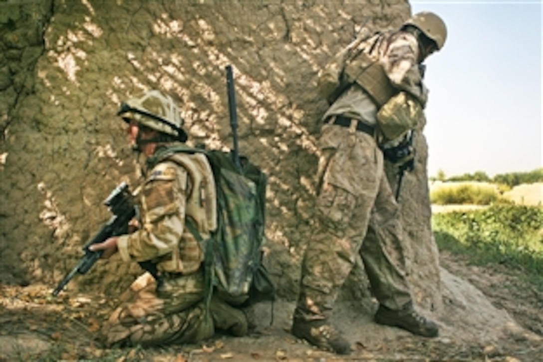 U.S. Marine Staff Sgt. Robert Jernigan peers around a corner while a U.K. soldier provides security during a patrol near Checkpoint North in Helmand province, Afghanistan, Sept. 23, 2009. Jernigan and fellow Marines serve as liaisons between the U.K.’s Task Force Helmand and the Marine brigade, also known as Task Force Leatherneck. Jernigan is a team leader assigned to the 2nd Air Naval Gunfire Liaison Company, Marine Expeditionary Brigade Afghanistan.