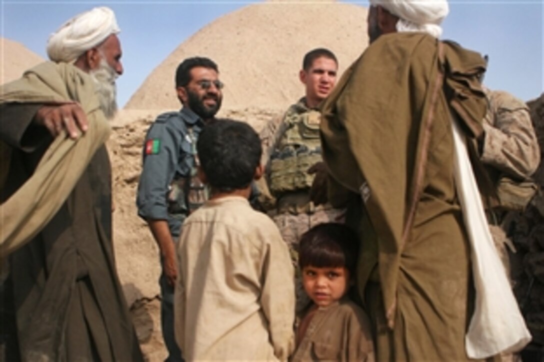 U.S. Marines 1st Lt. Marshall Pagaling and Sgt. Bill Frick say their farewells to Abdul Sala'am, an Afghan police chief, near Dewalak, Afghanistan,  Sept. 19, 2009, after meeting with villagers. Pagaling and Frick are assigned to the 2nd Battaltion, 3rd Marine Regiment.