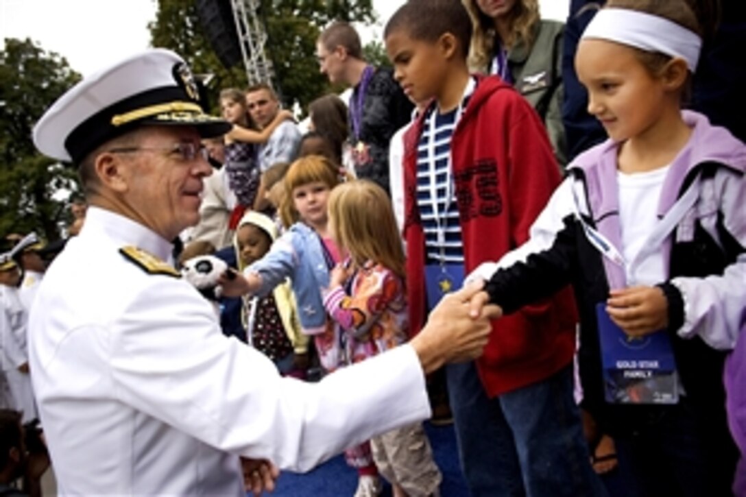 U.S. Navy Adm. Mike G. Mullen, chairman of the Joint Chiefs of Staff, greets the children of the nation's fallen heroes at the Fourth Annual Time of Remembrance ceremony honoring America's fallen heroes in Afghanistan and Iraq on the west lawn of the U.S. Capitol, Sept. 26, 2009.