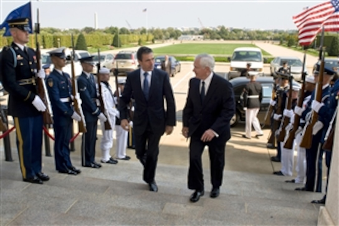 Secretary of Defense Robert M. Gates escorts NATO Secretary General Anders Fogh Rasmussen through an honor cordon and into the Pentagon on Sept. 28, 2009.  