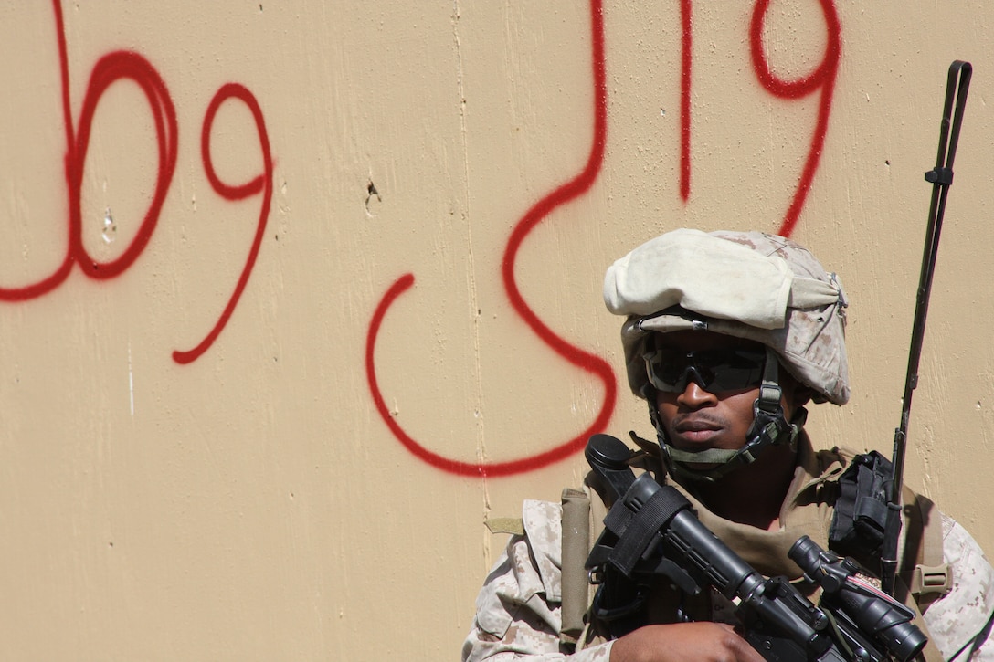 A Marine with Bravo Company, Battalion Landing Team 1st battalion, 9th Marine Regiment, 24th Marine Expeditionary Unit, stands watch at a simulated Afghan market during a two-day training cycle that all the BLT companies are completing as part of hte MEU's Realistic Urban Training exercise.