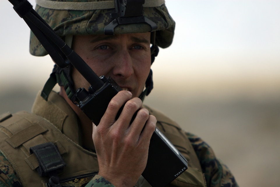 Capt. Brandon Stockwell, the air officer for 1st Battalion, 4th Marine Regiment, calls in an air resupply mission aboard the depot here Sept. 29. Stockwell, a La Fayette, Ind., native, said aircraft can be called in for multiple purposes, including air strikes and ammunition resupplies.