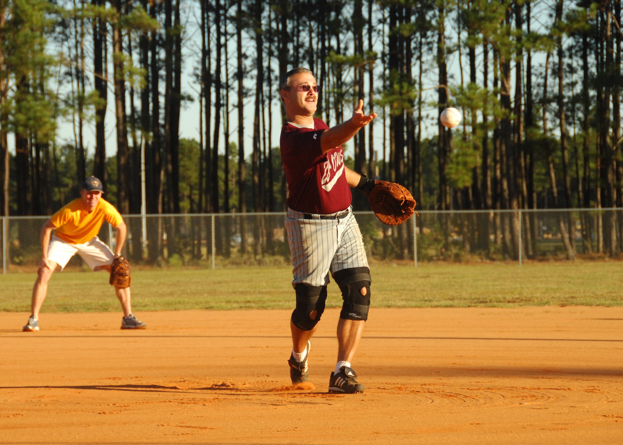 SHAW AIR FORCE BASE, S.C. -- Mike Bechicchia, retired Air Force, 28th Operational Weather Squadron, pitches during a Viper Challenge softball game while Lt. Col. Kenneth Ekman, 79th Fighter Squadron commander, prepares to make the play. (U.S. Air Force photo/2nd Lt. Emily Chilson)