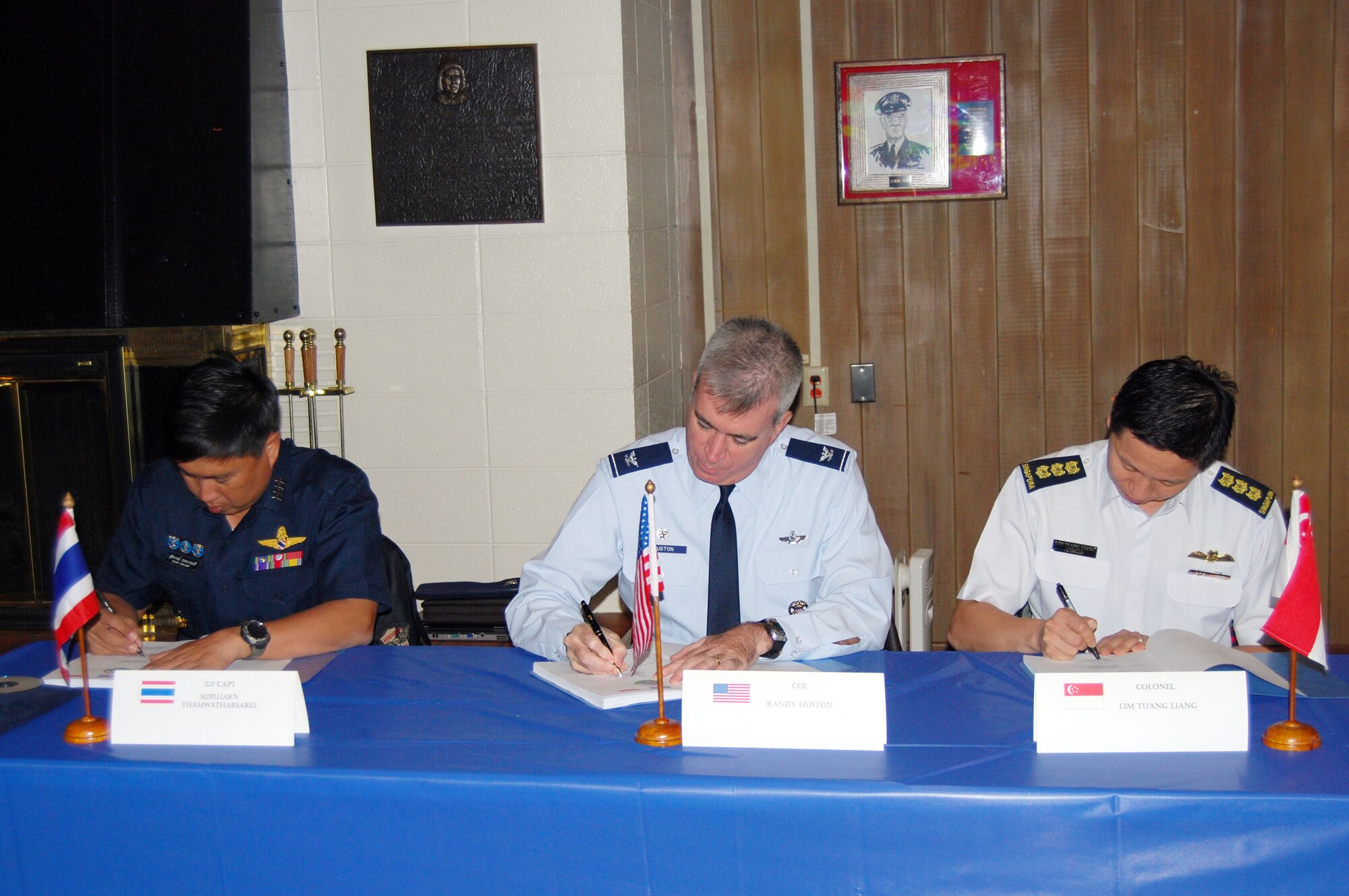 Group Capt. Supijjaran Thamwatharsaree, Royal Thai Air Force; Col. Robert “Randy” Huston, 624th Regional Support Group; and Col. Lim Tuang Liang, Republic of Singapore Air Force sign the conference minutes which put the final touches on the flight schedule and the large force employment plan for the upcoming Cope Tiger exercise in Thailand in March 2010 at a conference held Sept 21-25 at Elmendorf Air Force Base, Alaska. Cope Tiger is an annual, multilateral aerial exercise which divides Thai, Singaporean and U.S. Air Force, Navy and Marine Corps aircraft into two mixed groups, pitting them against each other in a mock battle. The exercise also includes a two-phase humanitarian and civic assistance portion (Courtesy photo)