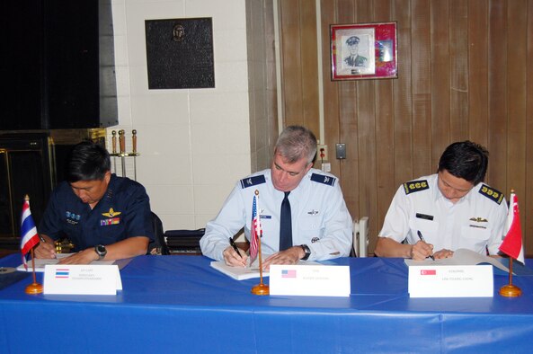 Group Capt. Supijjaran Thamwatharsaree, Royal Thai Air Force; Col. Robert “Randy” Huston, 624th Regional Support Group; and Col. Lim Tuang Liang, Republic of Singapore Air Force sign the conference minutes which put the final touches on the flight schedule and the large force employment plan for the upcoming Cope Tiger exercise in Thailand in March 2010 at a conference held Sept 21-25 at Elmendorf Air Force Base, Alaska. Cope Tiger is an annual, multilateral aerial exercise which divides Thai, Singaporean and U.S. Air Force, Navy and Marine Corps aircraft into two mixed groups, pitting them against each other in a mock battle. The exercise also includes a two-phase humanitarian and civic assistance portion (Courtesy photo)
