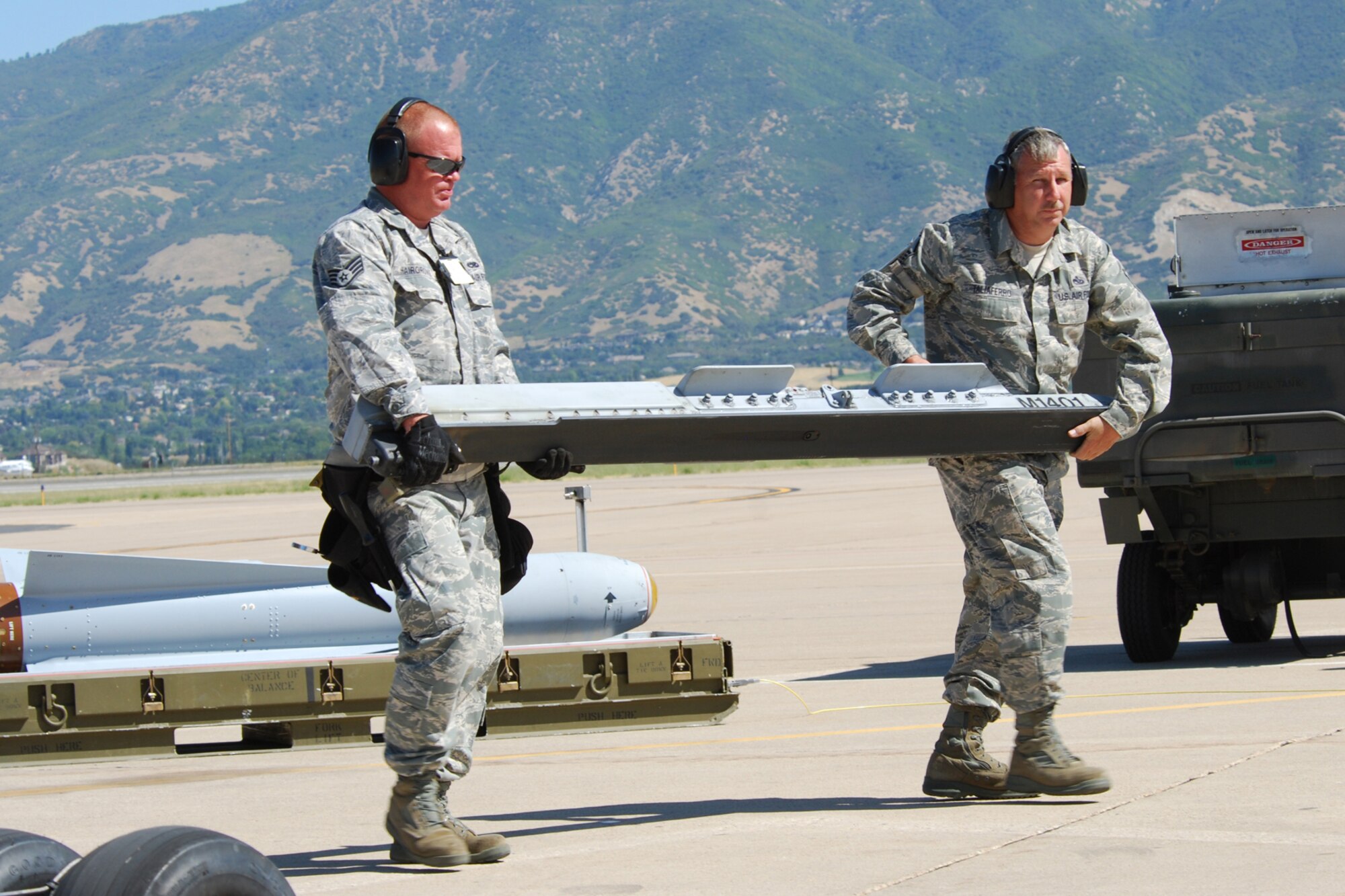 Staff Sgt. Jason Hairgrove, 717th Aircraft Maintenance Squadron, weapons loader, and Master Sgt. Richard Taliaferro, 717th AMXS, armament systems specialist, carry a LAU-117 missile rail to a 47th Fighter Squadron A-10 Thunderbolt II aircraft to facilitate loading of an AGM-65 Maverick missile in support of Patriot Rifle III, Hill Air Force Base, Utah, on September 12, 2009. More than 54 members of the 917th Wing from Barksdale Air Force Base, La., and six aircraft participated in the exercise.  (U.S. Air Force photo/Master Sgt. Greg Steele)