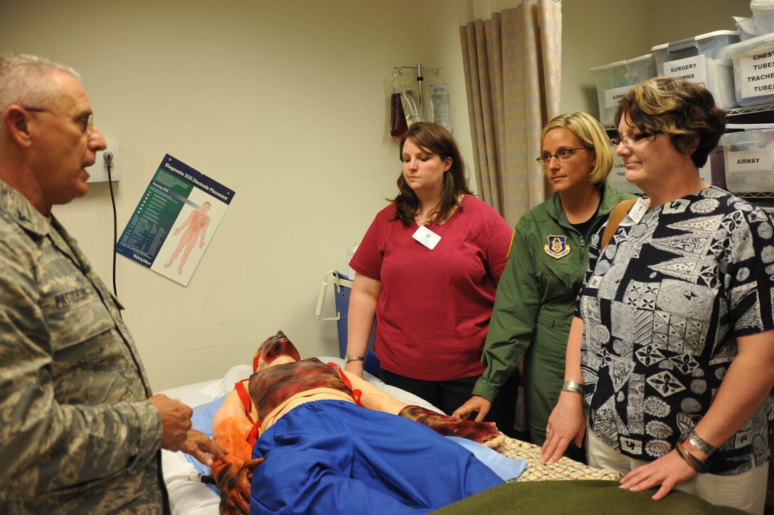 Colonel James Patterson explains the electronic workings of the simulation man "SIM MAN" robot inside the 932nd Airlift Wing's Medical Group building during a tour.  He is the Medica Group commander at the Air Force Reserve unit near Belleville, Illinois.  (U.S. Air Force
