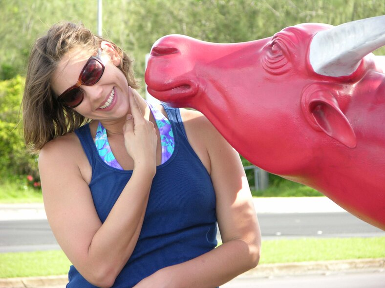 Staff Sgt. Jennifer Redente poses with a carabao off of Marine Corps Drive during her search to find all of the carabao statues on the island Aug. 2. Sergeant Redente, 36th Wing Public Affairs craftsman, has found 22 statues. The Guam Chamber of Commerce started the campaign, Carabaos on Vacation, in 2006, as a way to showcase Guam's culture. (Courtesy photo)
