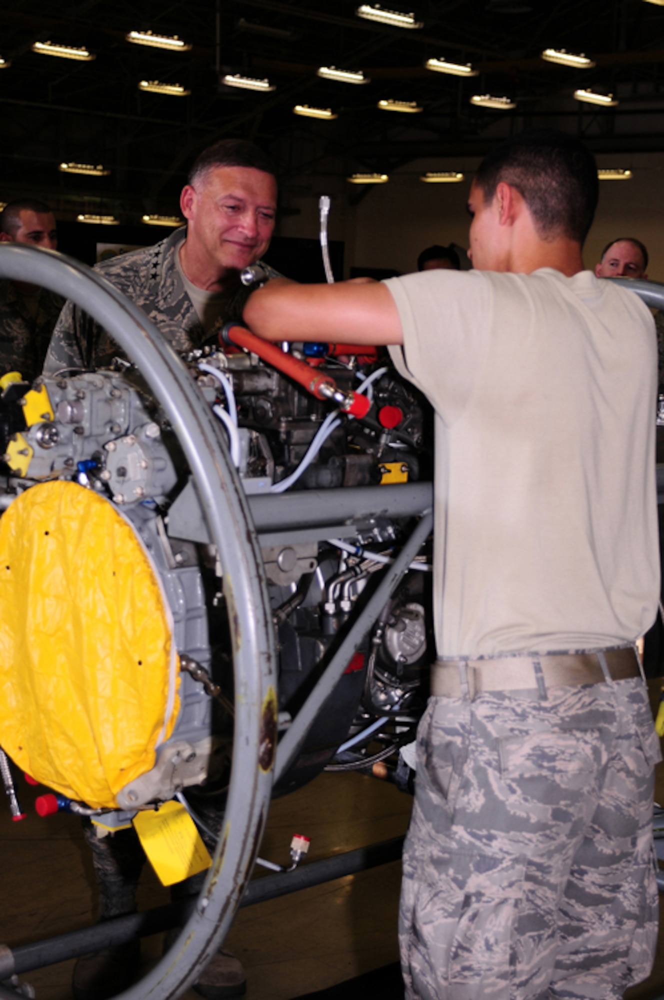 YOKOTA AIR BASE, Japan -- Gen. Gary North, Pacific Air Forces Commander, watches Airman 1st Class Jorge Espinosa-Velez, 374th Maintenance Squadron aerospace propulsions journeyman, work on a C-130 engine Sept. 24 during the general's first visit here since he took the reins of PACAF on Aug. 19. The general toured base facilities, hosted an Airman's Call and was the guest speaker at the base's Air Force Anniversary Ball during his visit. (U.S. Air Force photo/Airman 1st Class Michael Dillon)