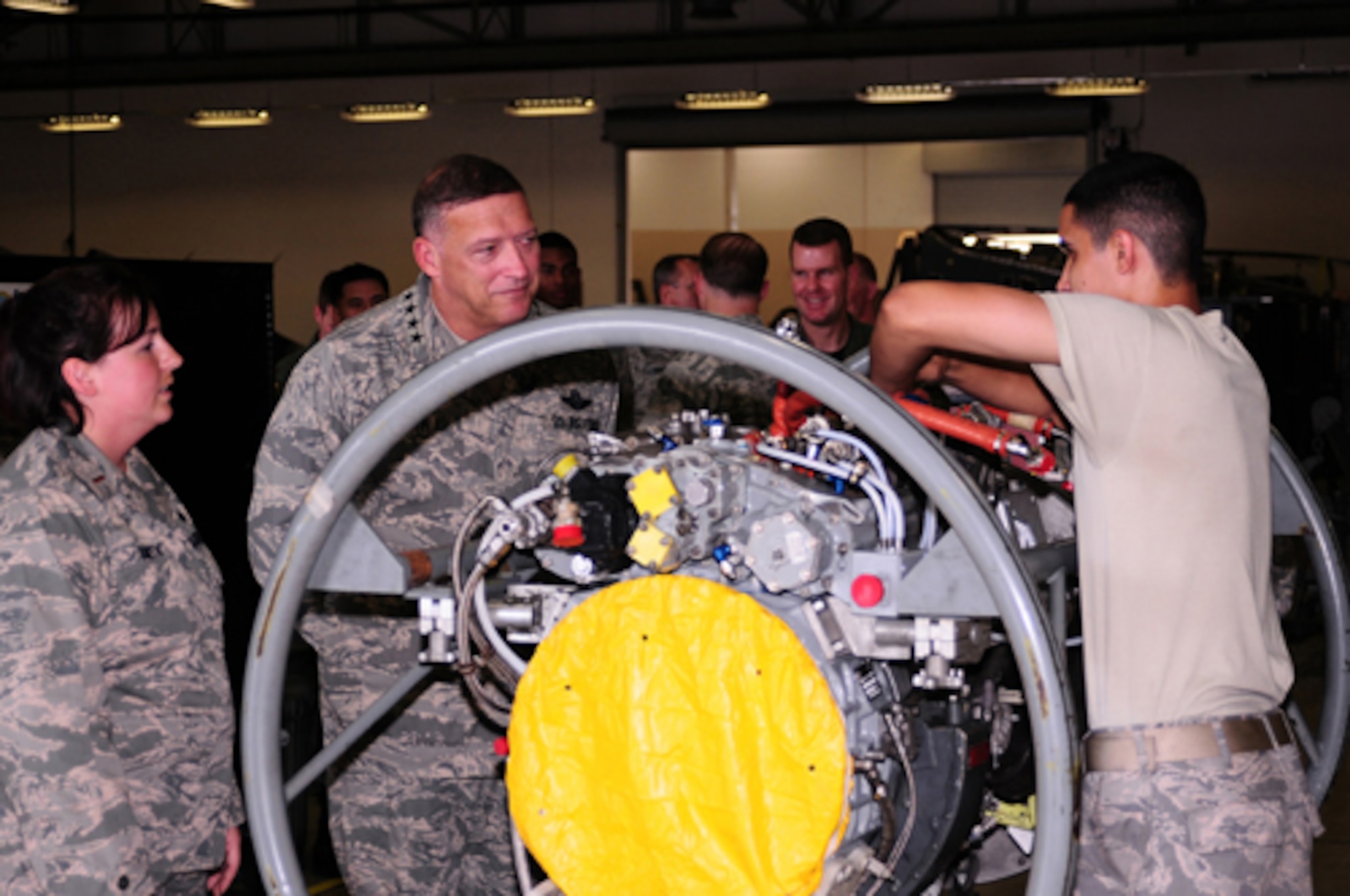 YOKOTA AIR BASE, Japan -- Gen. Gary North, Pacific Air Forces Commander, watches Airman 1st Class Jorge Espinosa-Velez, 374th Maintenance Squadron aerospace propulsions journeyman, work on a C-130 engine Sept. 24 during the general's first visit here since he took the reins of PACAF on Aug. 19. The general toured base facilities, hosted an Airman's Call and was the guest speaker at the base's Air Force Anniversary Ball during his visit. (U.S. Air Force photo/Airman 1st Class Michael Dillon)