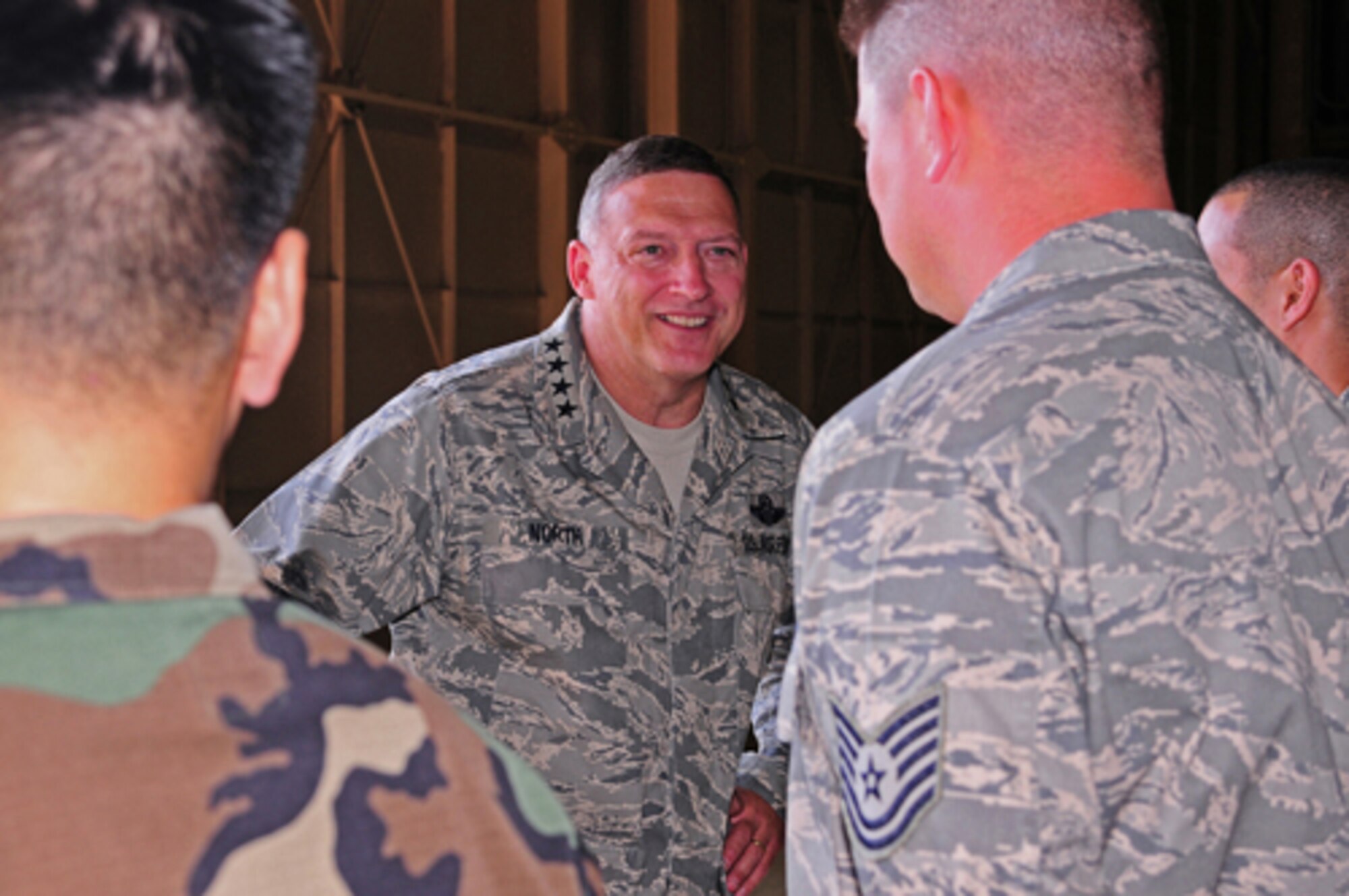 YOKOTA AIR BASE, Japan -- Gen. Gary North, Pacific Air Forces Commander, talks with Tech. Sgt. Anthony Price, 374th Maintenance Squadron NCO in charge of jet engine intermediate maintenance Sept. 24 during the general's first visit here since he took the reins of PACAF on Aug. 19. The general toured base facilities, hosted an Airman's Call and was the guest speaker at the base's Air Force Anniversary Ball during his visit. (U.S. Air Force photo/Airman 1st Class Michael Dillon)