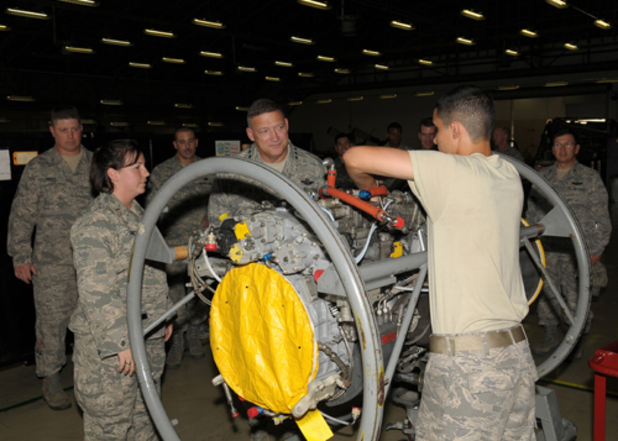YOKOTA AIR BASE, Japan -- Gen. Gary North, Pacific Air Forces Commander, watches Airman 1st Class Jorge Espinosa-Velez, 374th Maintenance Squadron aerospace propulsions journeyman, work on a C-130 engine Sept. 24 during the general's first visit here since he took the reins of PACAF on Aug. 19. The general toured base facilities, hosted an Airman's Call and was the guest speaker at the base's Air Force Anniversary Ball during his visit. (U.S. Air Force photo/Airman 1st Class Sean Martin)