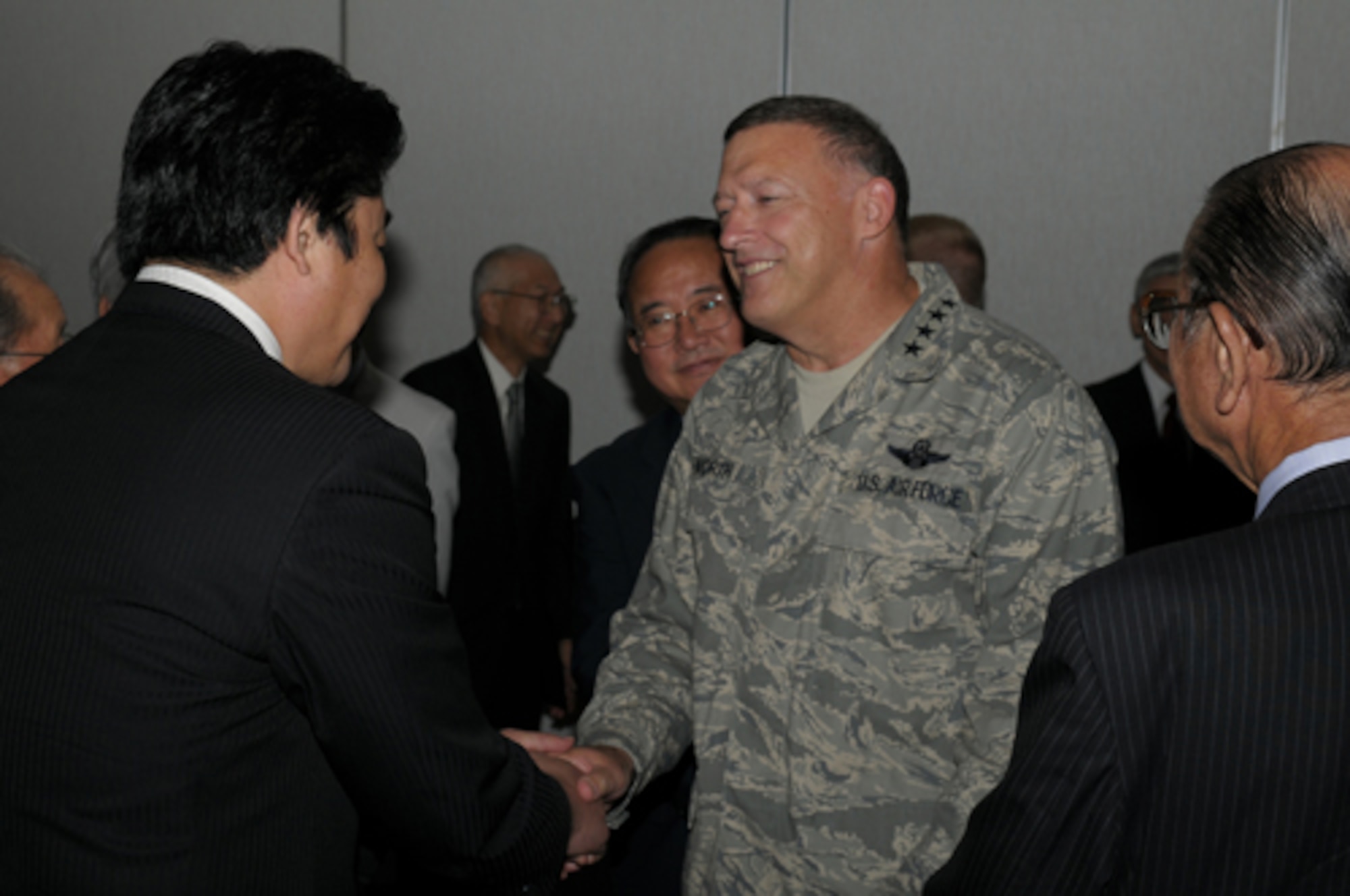 YOKOTA AIR BASE, Japan -- Gen. Gary North, Pacific Air Forces Commander, shakes hands with Ikuo Kato, Fussa City mayor, during a civic leaders' luncheon Sept. 24 during the general's first visit here since he took the reins of PACAF on Aug. 19. The general toured base facilities, hosted an Airman's Call and was the guest speaker at the base's Air Force Anniversary Ball during his visit. (U.S. Air Force photo/Airman 1st Class Sean Martin)