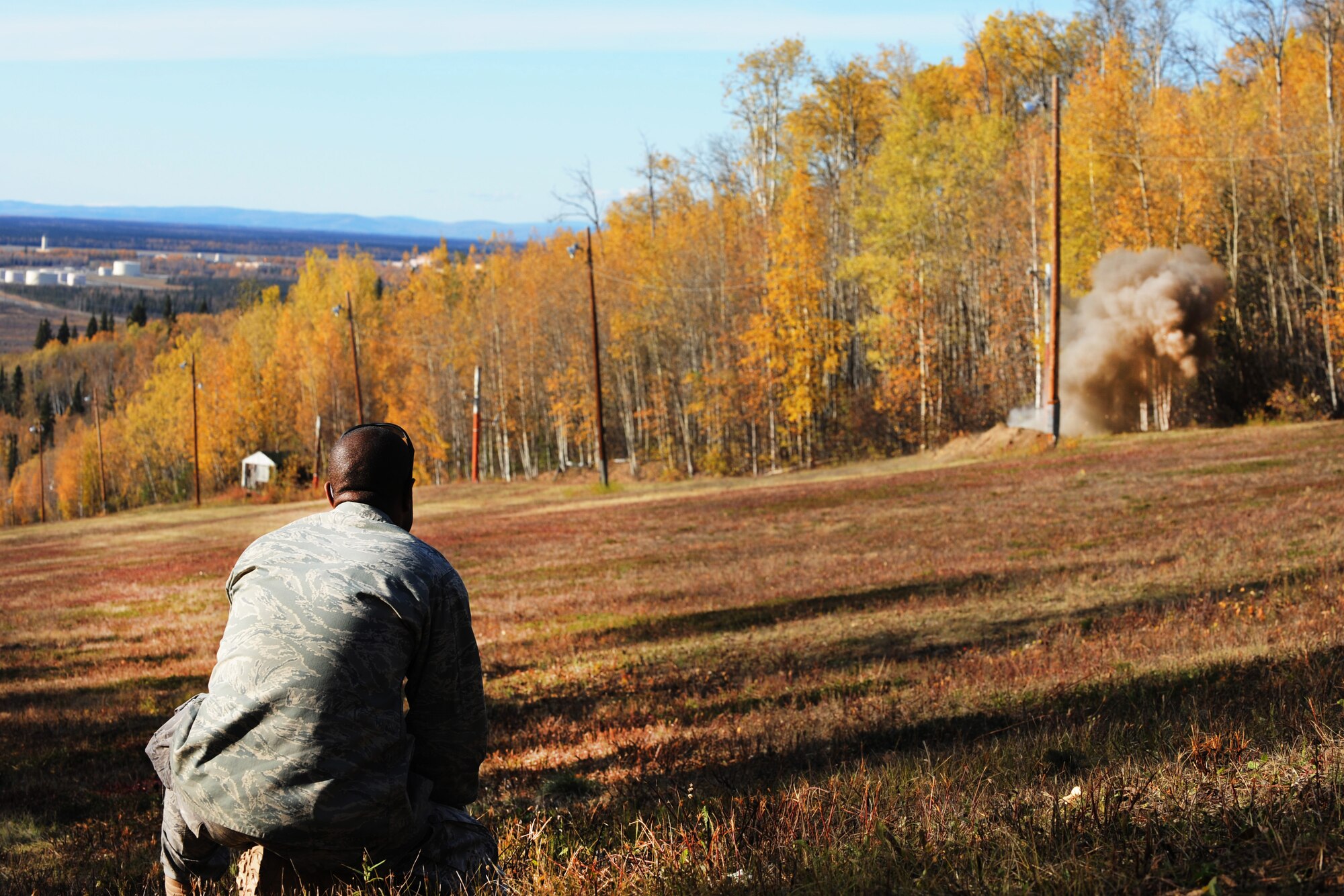Senior Airman Dave Thomas detonates explosive to remove a ski lift pole from the ground Sept. 24, 2009, Eielson Air Force Base, Alaska. The 354th explosive ordinance flight assisted base civil engineers with removing the old ski lift poles to make way for a new lift to be assembled. Airman Thomas is assigned to the 354th Civil Engineer Squadron Explosive Ordinance Disposal Flight. (U.S. Air Force photo/Airman 1st Class Laura Goodgame)