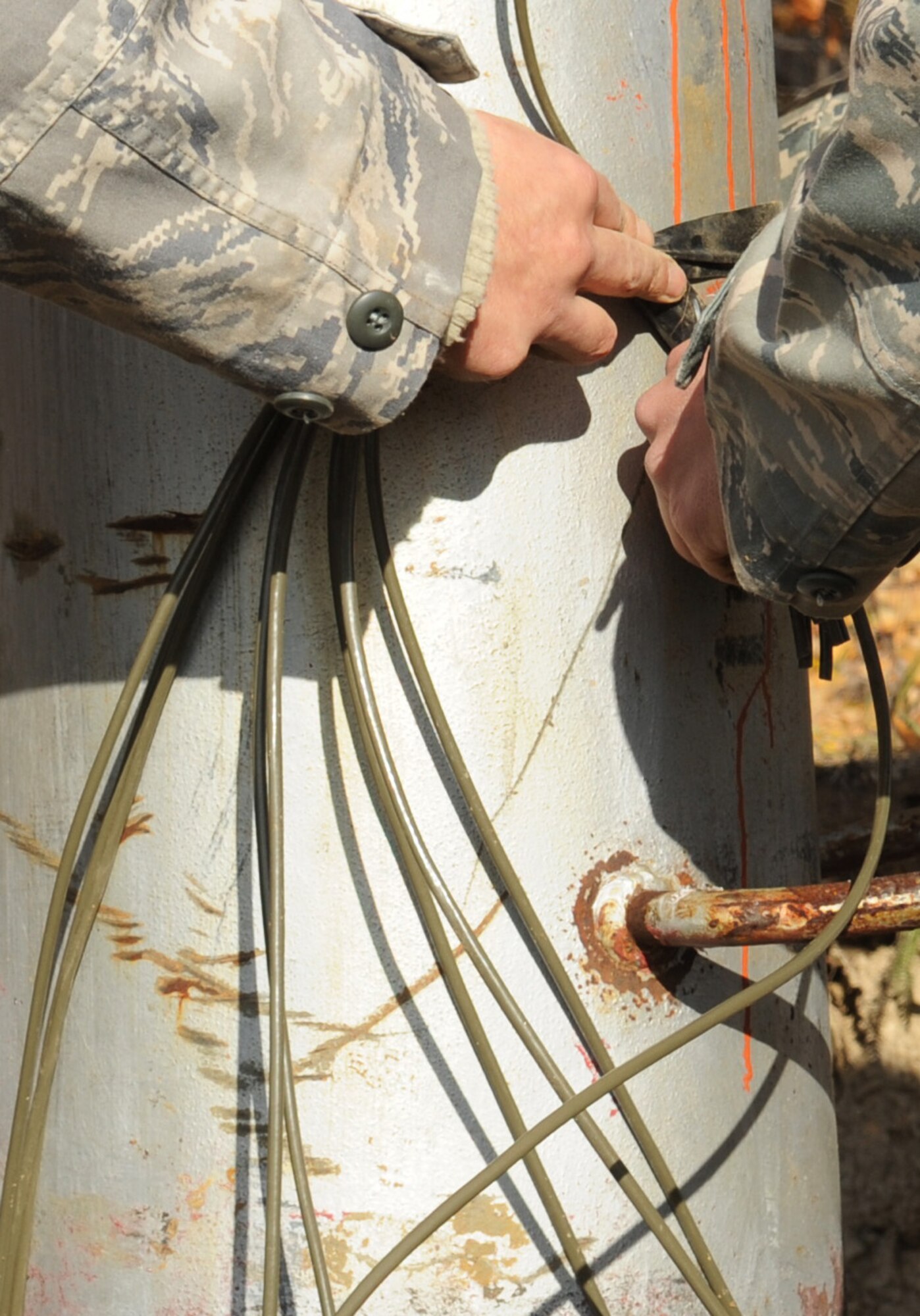 Airmen with the 354th Civil Engineer Squadron Explosive Ordinance Disposal Flight tie fire wire together Sept. 24, 2009, Eielson Air Force Base, Alaska. EOD is assisting with removing the old ski lift at Eielson in preparation for a new lift system. (U.S. Air Force photo/Airman 1st Class Laura Goodgame)