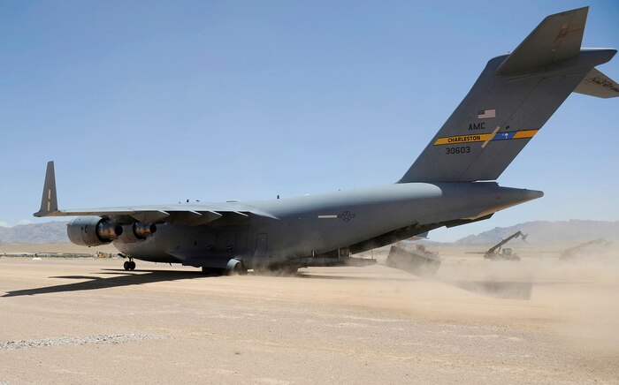 A pallet is combat off-loaded from a Charleston AFB C-17 June 20 at Tarin Kowt Airfield, Afghanistan. A recent test conducted by Air Mobility Command on semi-prepared runway operations worldwide may help the C-17 be able to reach more forward operating locations such as Tarin Kowt. (U.S. Air Force photo/Staff Sgt. Shawn Weismiller)