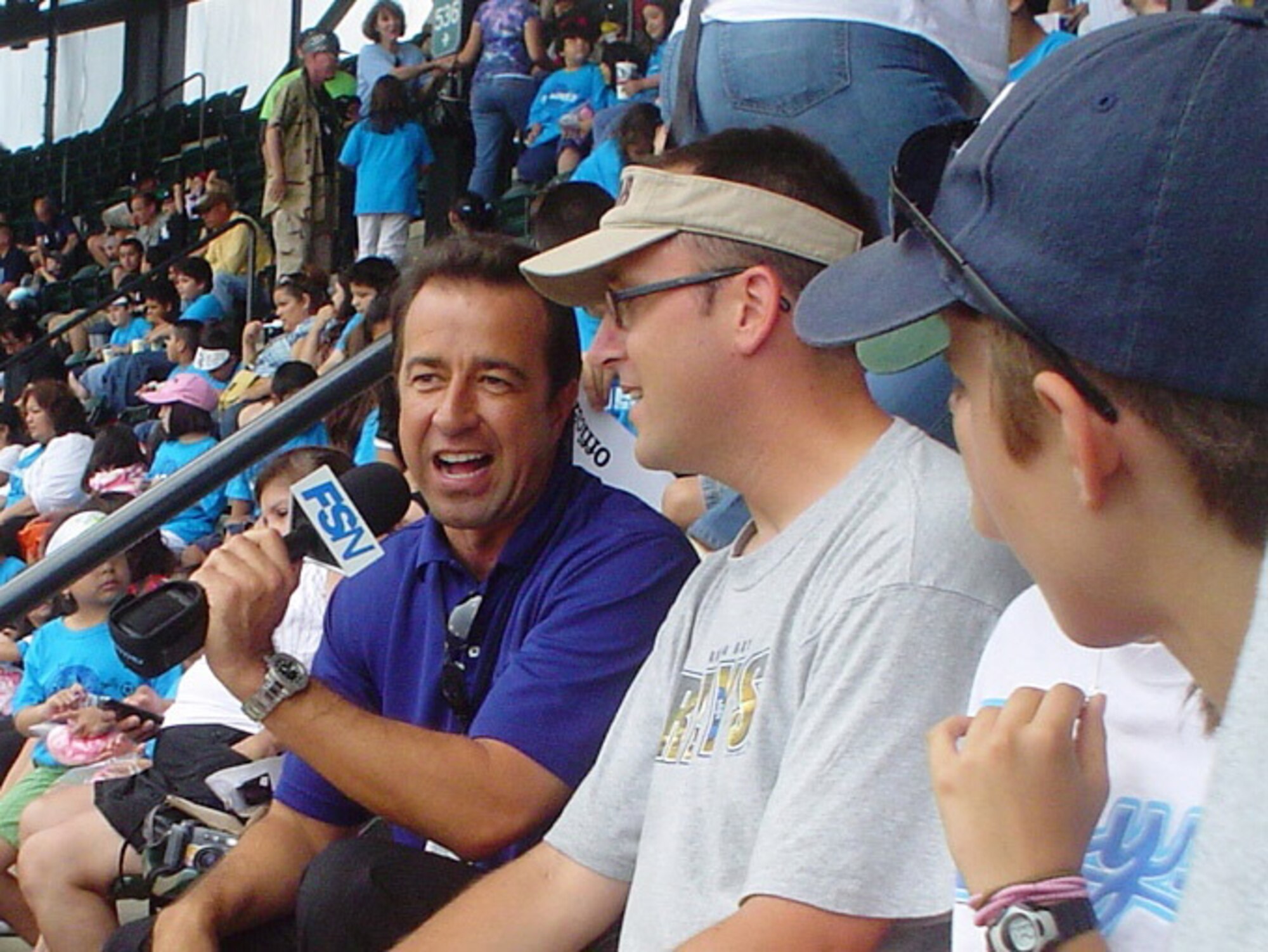 Tampa Bay Rays announcer Todd Kalas interviews Master Sgt. Brady Kiel, 932nd Airlift Wing historian and baseball fan, in Chicago.  White Sox teammates mobbed pitcher Mark Buehrle after completing just the 18th perfect game ever pitched in Major League Baseball history. Sergeant Kiel was glad to be on hand for the historic moment after becoming a Rays fan while he served at the Headquarters U.S. Central Command in Florida.  (Photo submitted by MSgt. Brady Kiel)