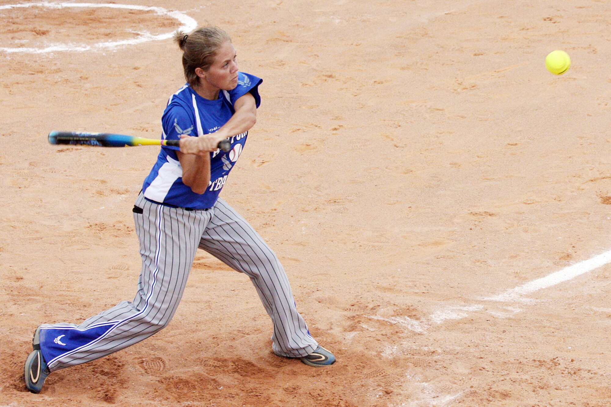 Kathy Braun gets a base hit during the Armed Forces Softball Championships. The Air Force men's and women's softball teams earned gold medals at the event. Braun is from Offutt Air Force Base, Neb. (U.S. Air Force photo/Steve Brown) 
