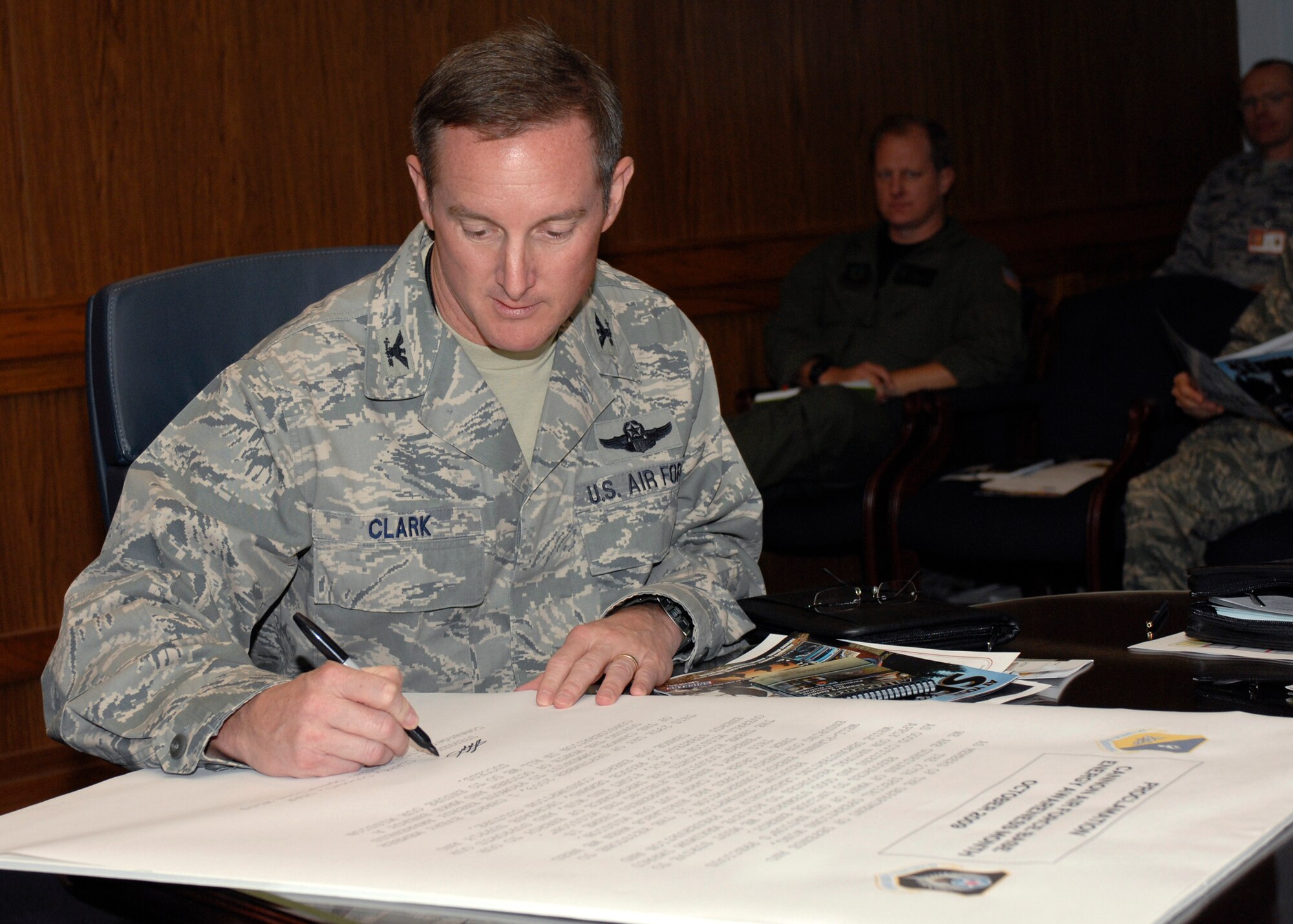 CANNON AIR FORCE BASE, N.M.-- Col. Stephen Clark, 27th Special Operations Wing commander, signs the proclamation for energy awareness month to be October in the wing building Sep. 29.  During the month of October the base will try to save money by cutting back on energy used for the daily mission.  (U.S. Air Force photo by Airman 1st Class James Bell)