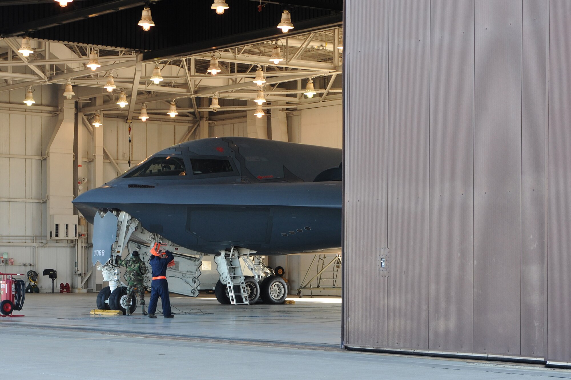 WHITEMAN AIR FORCE BASE, Mo. - Airman 1st Class Cartine Glenn and Senior Airman Mark Decumen, 509 Aircraft Maintenance Squadron crew chiefs, prepare the B-2 Spirit for launch as the bay doors open after the exercise alert call during the Nuclear Operation Readiness Exercise "Beast Walk," Sept 29. The NORE is in preparation of the Nuclear Operational Readiness Inspection Cot. 11. (U.S. Air Force photo/Airman 1st Class Carlin Leslie)