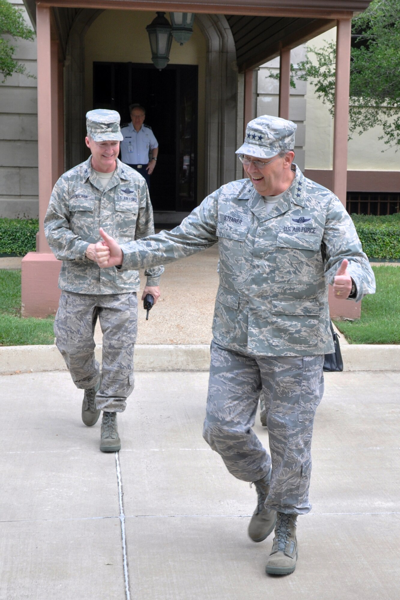 Col. Edmund Walker, commander, 917th Wing, flashes a grin while Lt. Gen. Charles E. Stenner, Jr., commander, Air Force Reserve Command, gives the thumbs up as he wraps up a successful visit to Barksdale Air Force Base, La., on September 25, 2009. General Stenner traveled to Barksdale for a meeting with Lt. Gen. Frank Klotz, (background) who is commander of the Global Strike Command, now headquartered here. While on base, General Stenner also met with Col. Steven Basham, 2nd Bomb Wing, commander, toured the 47th Fighter Squadron facilities, the 93rd Bomb Squadron headquarters building and Hangar 1, where maintenance is accomplished on B-52 Stratofortresses for the 917th Wing. (U.S. Air Force photo/Tech. Sgt. Jeff Walston)