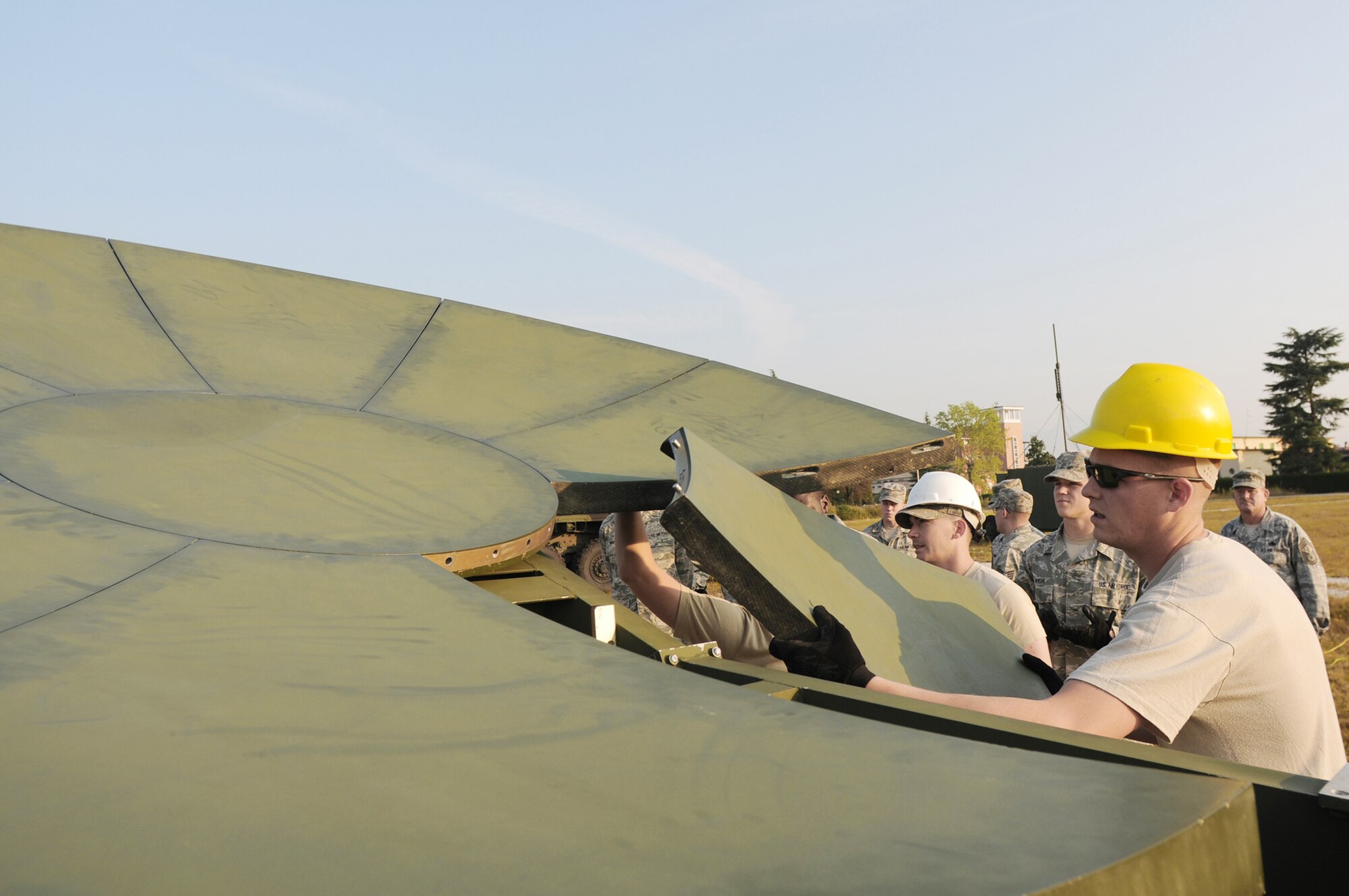 Staff Sgt. Nathon Wheat, a radio maintainer with the 1st Combat Communications Squadron at Ramstein Air Base, Germany, inserts the final panel into the center hub of a satellite dish Sept. 22, 2009, during a training exercise at Aviano AB, Italy. Sergeant Wheat and other radio and satellite communications Airmen on his team conducted cross-flow training in preparation for the upcoming merger into the new transmission systems career field in October 2009. (U.S. Air Force photo/Staff Sgt. Patrick Dixon)