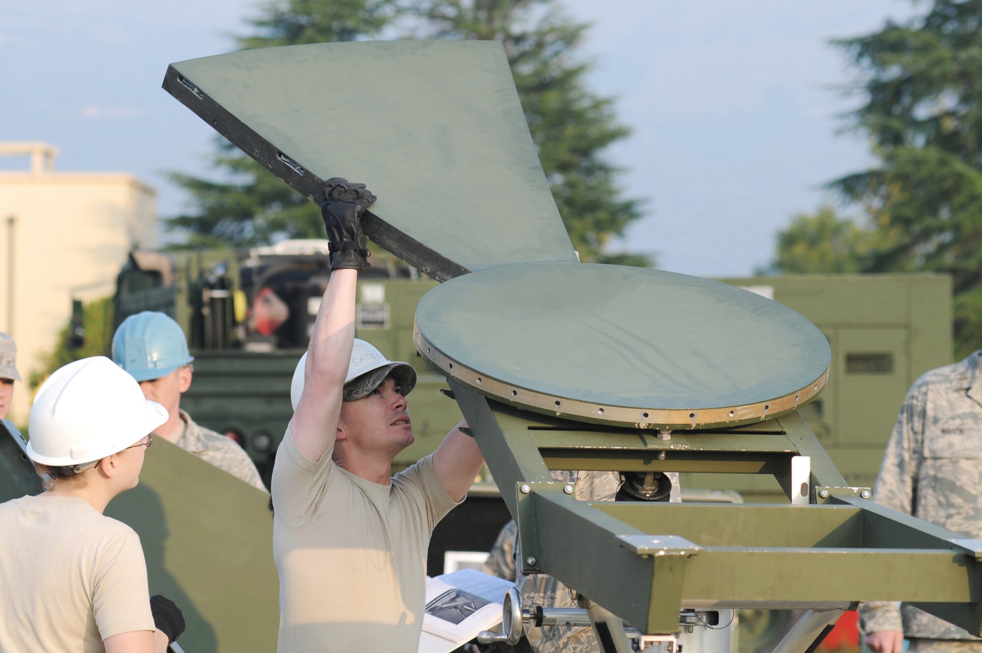 Tech. Sgt. Jonathan Gifford,  a 1st Combat Communications Squadron ground and radio maintainer from Ramstein Air Base, Germany, inserts the first panel into the center hub of a satellite dish Sept. 22, 2009, during a training exercise at Aviano AB, Italy. Sergeant Gifford and other radio and satellite communications Airmen on his team conducted cross-flow training in preparation for the upcoming merger into the new transmission systems career field in October 2009. (U.S. Air Force photo/Staff Sgt. Patrick Dixon)