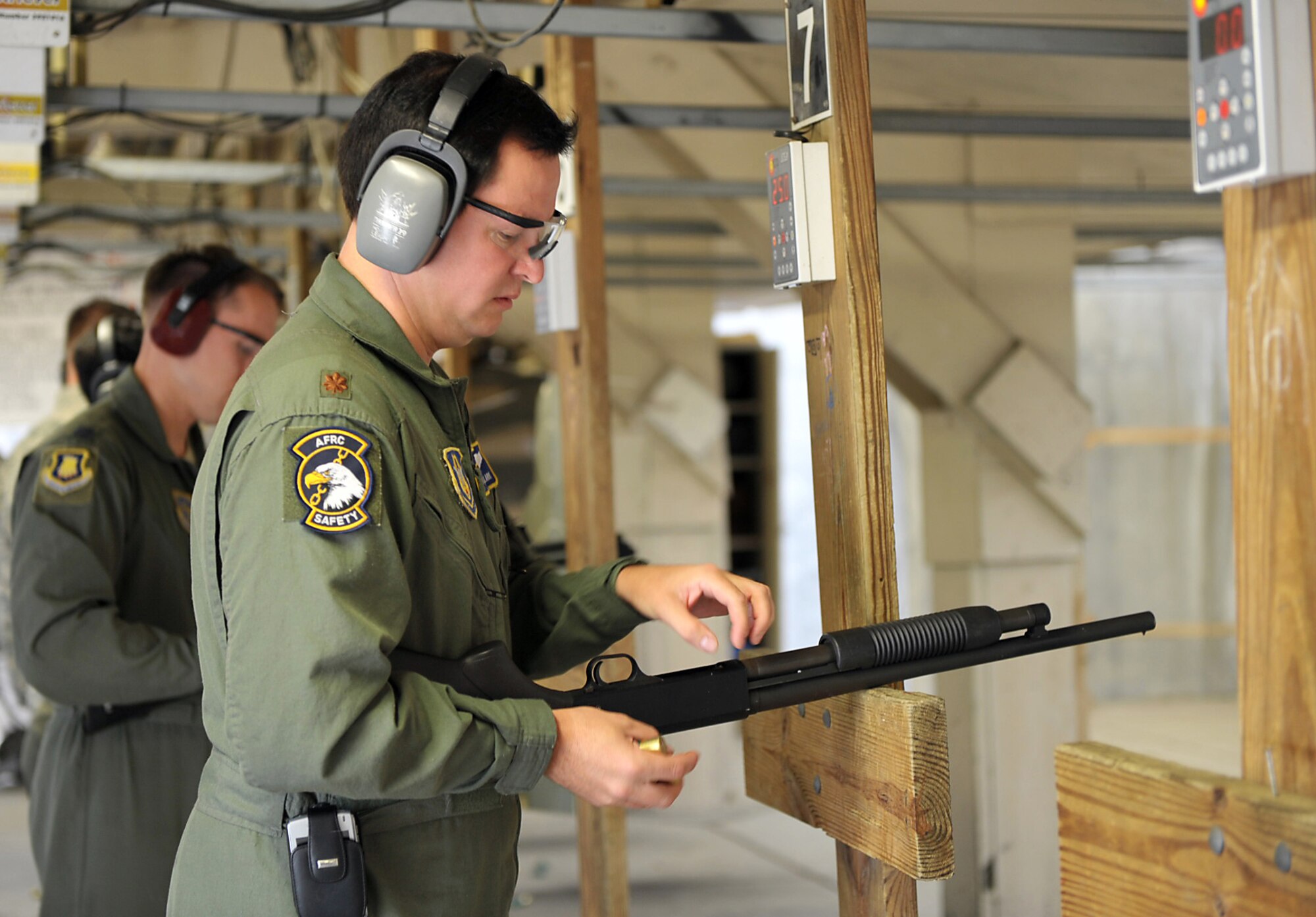 Maj. Travis Clark loads ammunition into a shotgun he fired Sept. 16, 2009, during a weapons qualification course for flight safety officers at McConnell Air Force Base, Kan. Major Clark, chief of safety for Air Force Reserve Command's 931st Air Refueling Group, attended the course with safety officers assigned the 22nd Air Refueling Wing, the host unit at McConnell. (U.S. Air Force photo/Tech. Sgt. Jason Schaap)