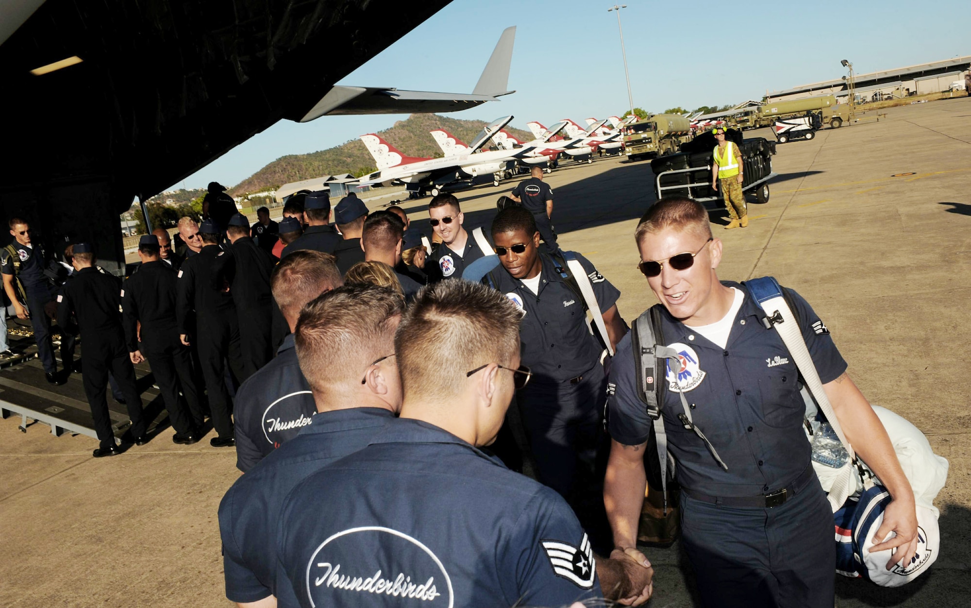 The Air Force Thunderbirds greet one another as members disembark from a C-17 Globemaster III Sept. 21, 2009, in Townsville, Australia. (U.S. Air Force photo/Staff Sgt. Kristi Machado)