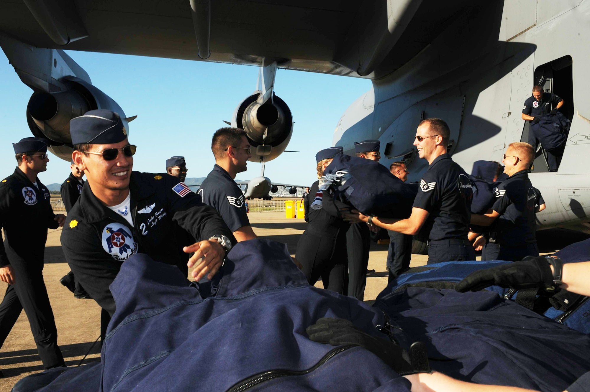 The Air Force Thunderbirds team unload their gear off of a C-17 Globemaster III Sept. 21, 2009, in Townsville, Australia. (U.S. Air Force photo/Staff Sgt. Kristi Machado)