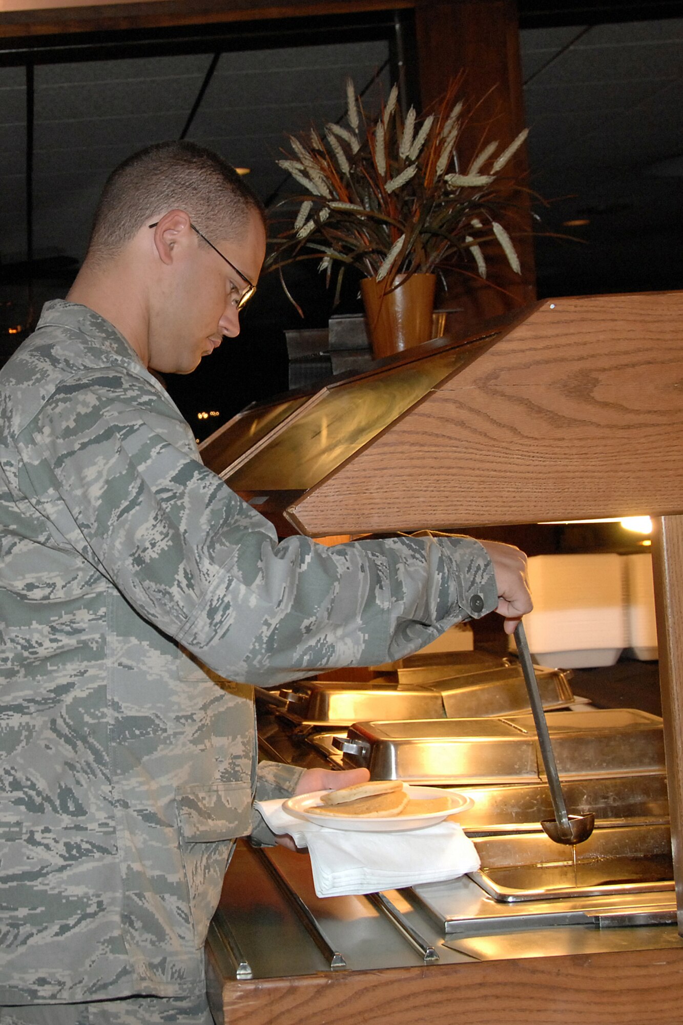 OFFUTT AIR FORCE BASE, Neb. - 1st Lt. Dale Ellis, 55 Aerospace Maintenance Squadron, Aircraft Support Flight officer-in-charge, tops off his pancakes with syrup during the Chief's Pancake Feed Sept. 23 at the Patriot Club. Offutt?s chief master sergeants prepared all-you-can-eat meals of sausage, eggs, fruit and pancakes as part of their annual fundraiser. U.S. Air Force photo by Kendra Williams.