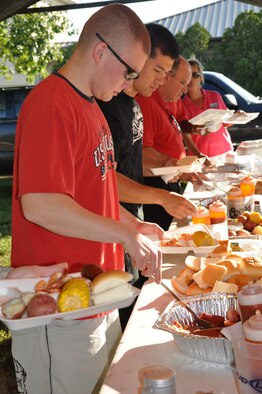 Airmen 1st Class Adam Huey, 96th Medical Support Squadron and Neil Johnson, 96th Communications Squadron go through the line during a dorm resident shrimp boil sponsored by the Niceville-Valparaiso Chamber of Commerce Military Affairs Committee Sept. 25 here.  More than 150 Airmen took part in the event aimed at showing appreciation to Eglin’s most junior members.(Air Force photo/ Staff Sgt. Bryan Franks)