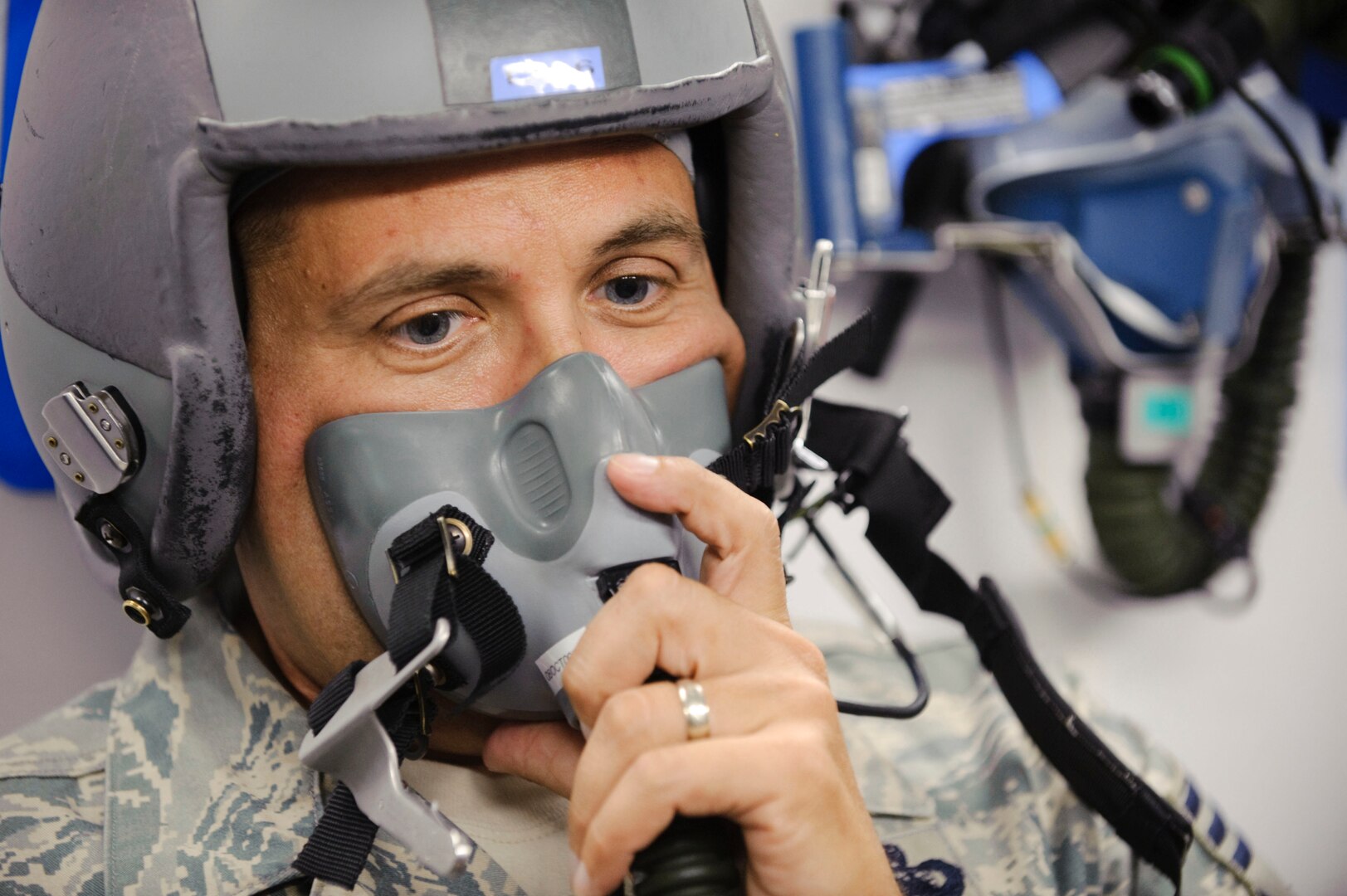 Chief Master Sgt. Max Grindstaff, 12th Flying Training Wing command chief from Randolph Air Force Base, Texas watches the flow indicator on oxygen regulator inside the bases high altitude chamber during training with the 12th Medical Group Aerospace Physiology technicians. (U.S. Air Force photo/Steve Thurow)