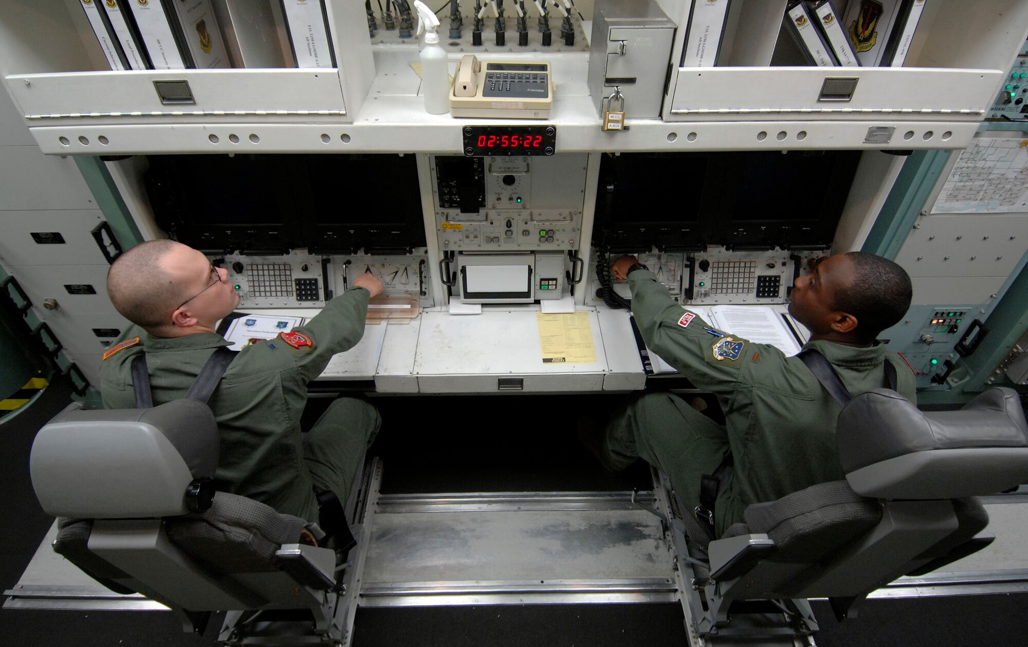 MINOT AIR FORCE BASE, N.D. -- 1st Lt. Jeremy King (left) and 2nd Lt. Glen Jasper (right), both from the 740th Missile Squadron, simulate launching a Minuteman III intercontinental ballistic missile at the missile procedure trainer here Sept. 24. Lieutenants King and Jasper performed the simulation as part of an 91st Missile Wing operations competition. (U.S. Air Force photo by Senior Airman Matthew Smith)  