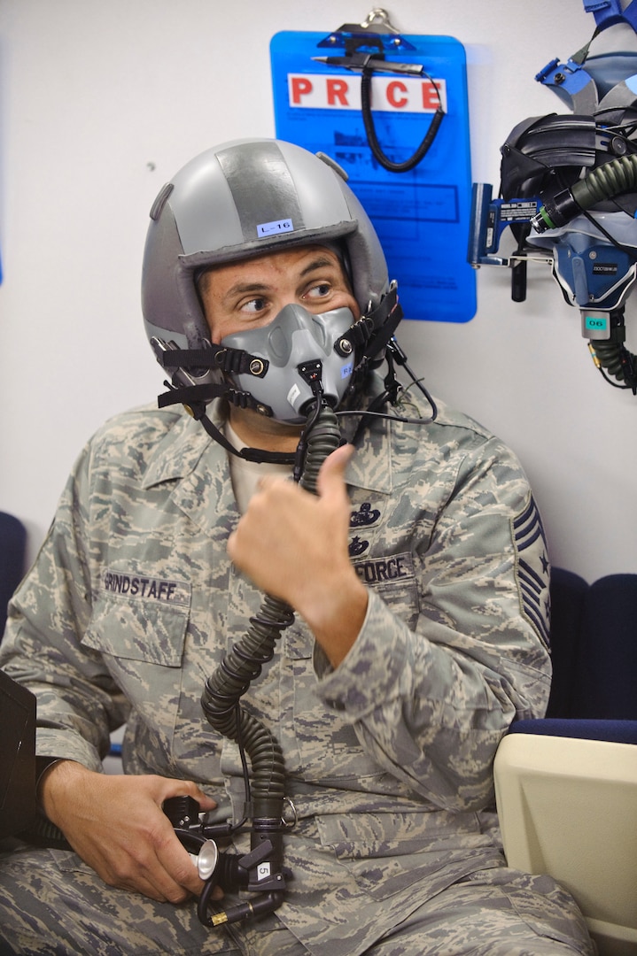 Chief Master Sgt. Max Grindstaff, 12th Flying Training Wing command chief from Randolph Air Force Base, Texas, signals 12th Medical Group high altitude chamber operator with a 'thumbs up,' to confirm that all equipment is operational before proceeding to 25,000 feet. (U.S. Air Force photo/Steve Thurow)