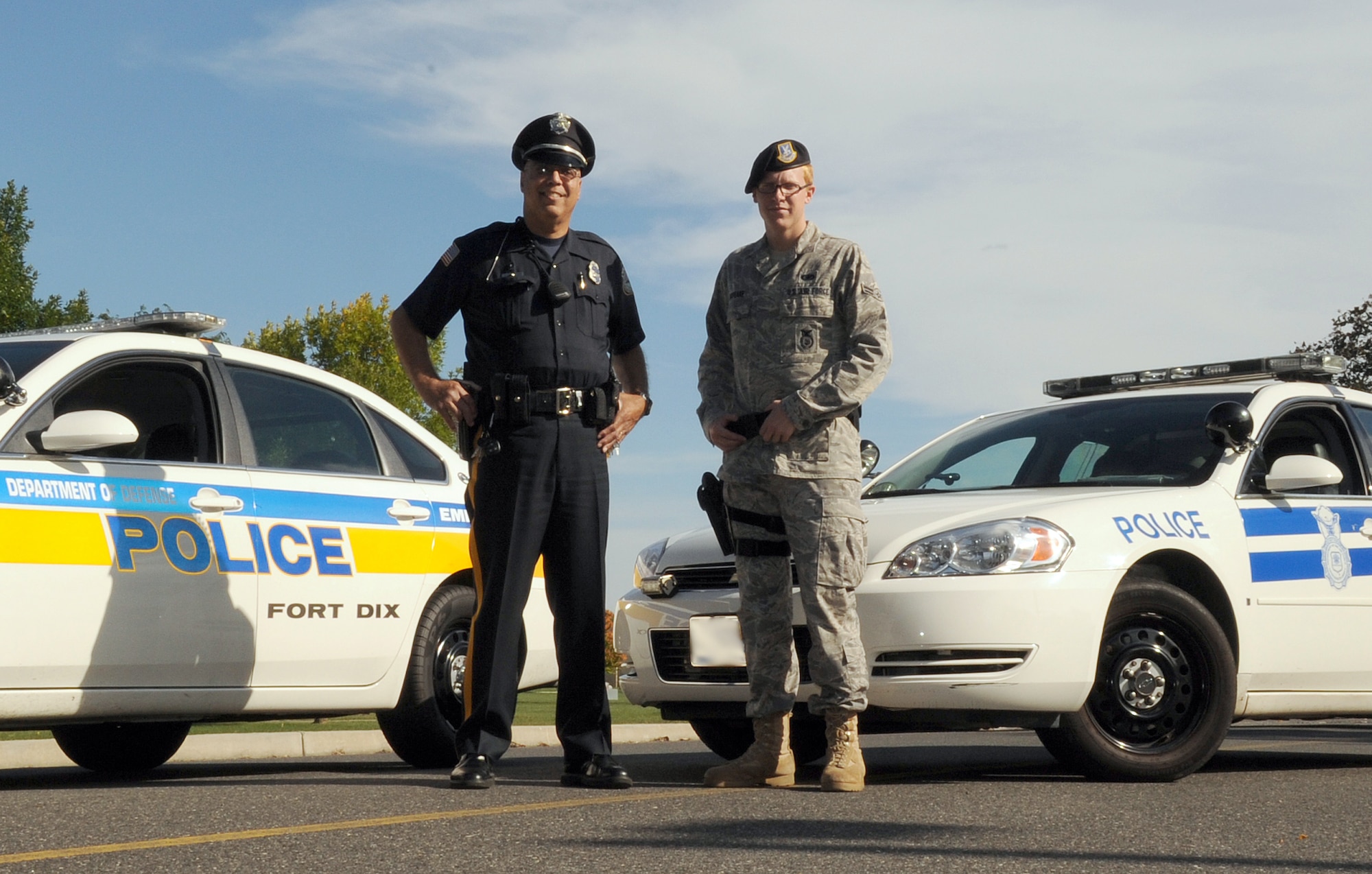 Randall Calderon Sr., a Department of Defense police patrolman at Fort Dix, N.J., and Airman 1st Class Alexander McPeake, an 87th Security Forces Squadron patrolman at McGuire Air Force Base, N.J., work together to ensure the safety and security of Joint Base McGuire-Dix-Lakehurst, N.J. (U.S. Air Force photo illustration/Staff Sgt. Danielle Johnson)